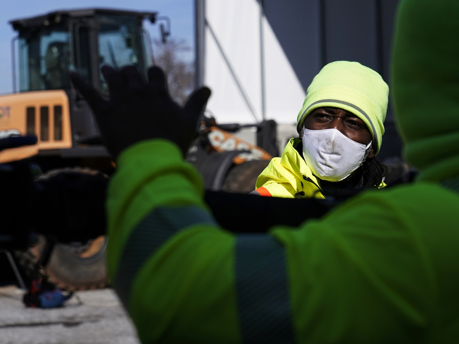 A Georgia Department of Transportation response member looks at a brine truck tank being filled ahead of a winter storm in Forest Park, Ga., on Friday.