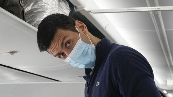 Novak Djokovic prepares to take his seat on a plane to Belgrade, in Dubai, United Arab Emirates, Monday, Jan. 17, 2022.