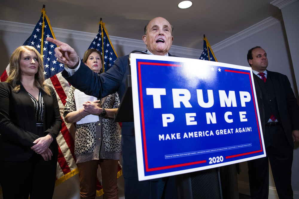 Rudy Giuliani, attorney for then-President Donald Trump, conducts a news conference at the Republican National Committee on lawsuits regarding the outcome of the 2020 presidential election on Nov. 19, 2020. Trump attorneys Jenna Ellis, far left, and Sydney Powell, second from left, and Boris Boris Epshteyn, right, also appear. (CQ-Roll Call, Inc via Getty Images)