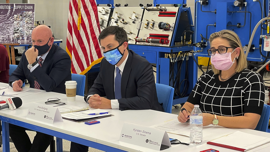 Arizona Democratic Sens. Sinema and Mark Kelly, along with Transportation Secretary Pete Buttigieg, center, listen during a roundtable about infrastructure and supply chain problems at Mesa Community College in Mesa, Ariz. on Nov. 19, 2021. Sinema helped craft the bipartisan infrastructure law, and has made her mark in the Senate working across the aisle.