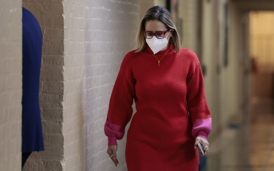 Sen. Kyrsten Sinema, D-Ariz., walks to her office in the basement of the U.S. Capitol building on Wednesday. Her positions on the filibuster and other issues have drawn threats of a primary challenge in Arizona.