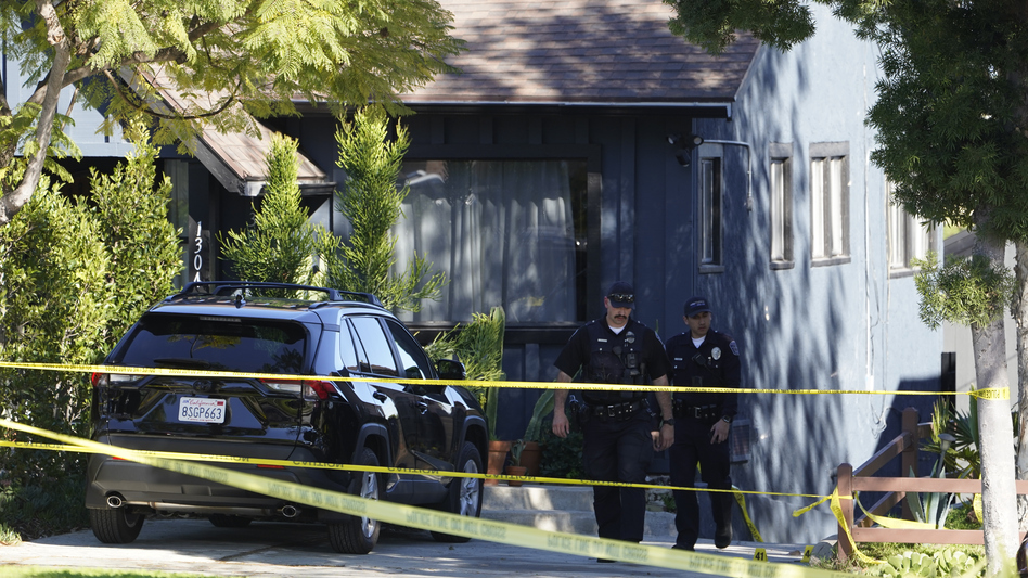 Police investigators leave a crime scene at a home in Inglewood, Calif., on Sunday. (Damian Dovarganes/AP)