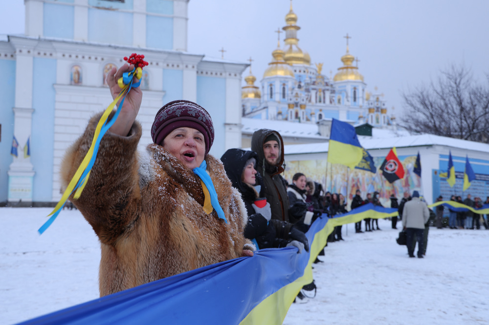 People rallying in patriotic support of Ukraine hold a 500 meter long ribbon in the colors of the Ukrainian flag outside St. Michael's Golden-Domed Monastery on Unity Day on Saturday in Kyiv, Ukraine. (Getty Images)