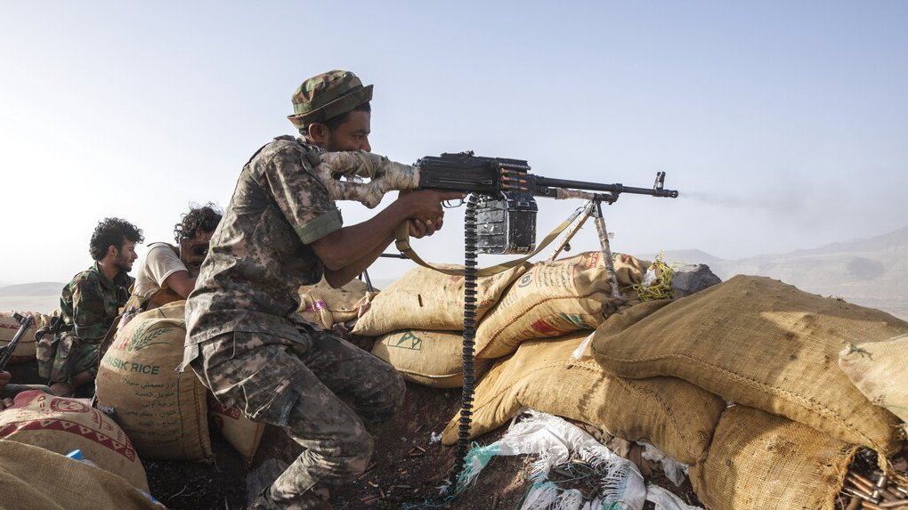 A Yemeni fighter backed by the Saudi-led coalition fires his weapon during clashes with Houthi rebels on the Kassara frontline near Marib, Yemen, Sunday, June 20, 2021.