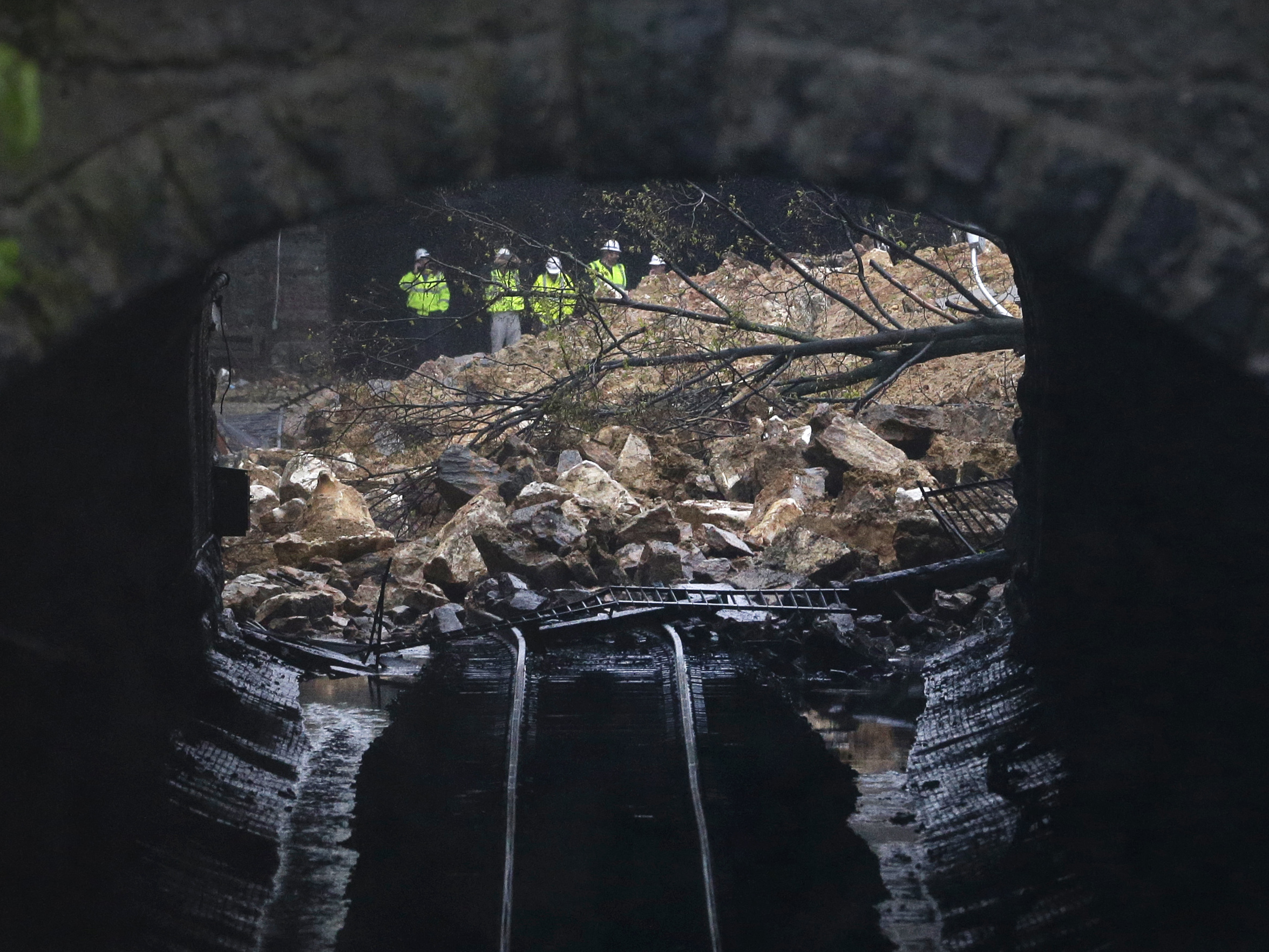 A road collapsed onto train tracks in Baltimore, Md. in 2014 after heavy rain. The city is facing millions of dollars in infrastructure upgrades to cope with the effects of climate change. (AP)