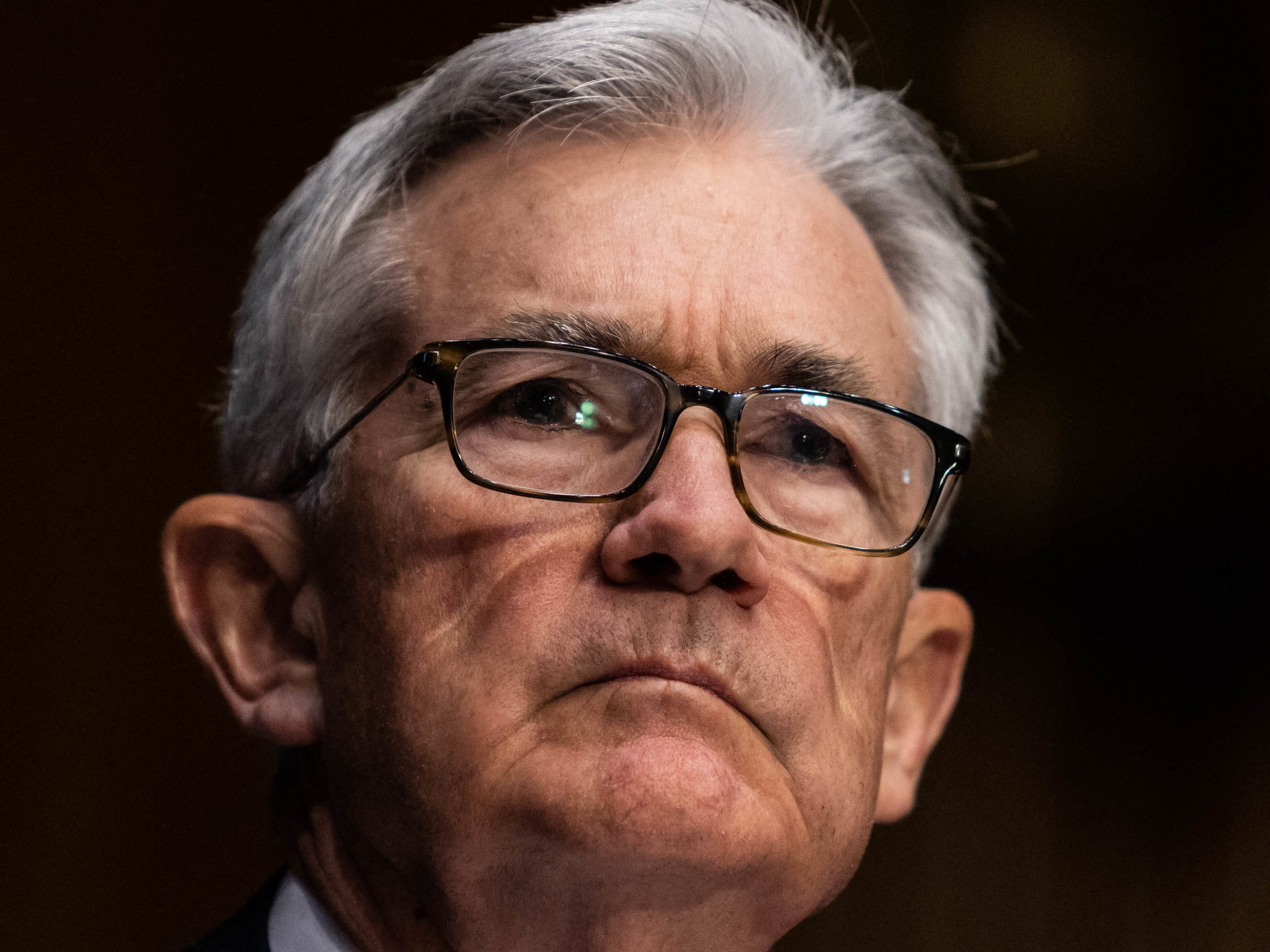 Federal Reserve Chair Jerome Powell listens during his renomination hearing with the Senate Banking Committee on Jan. 11. The Fed is planning to become more aggressive in fighting inflation. (Pool/AFP via Getty Images)