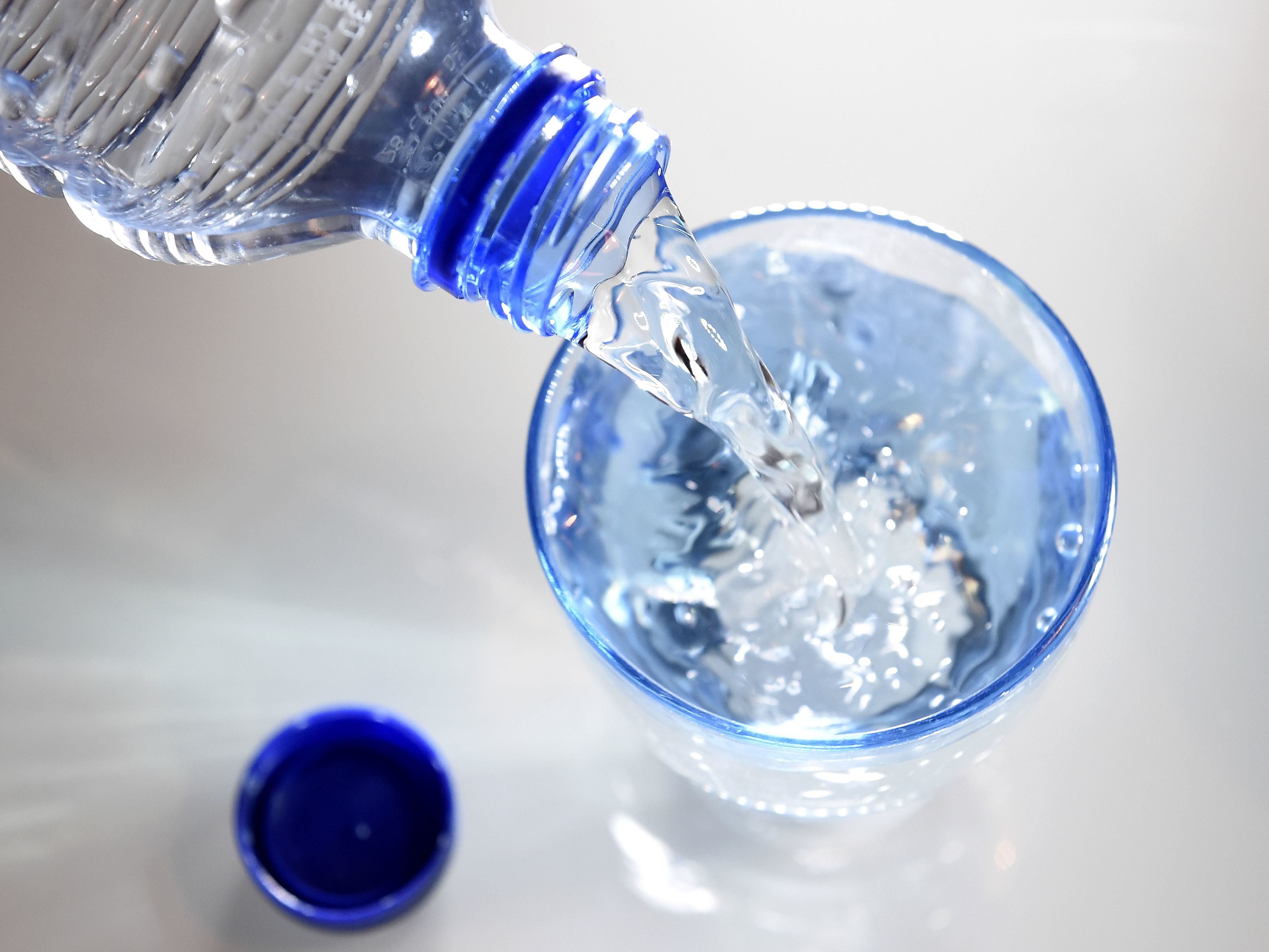 A glass is filled in with water on April 27, 2014 in Paris. Scientists studying what makes us thirsty have found the body checks in on our water consumption in several different ways. (AFP via Getty Images)