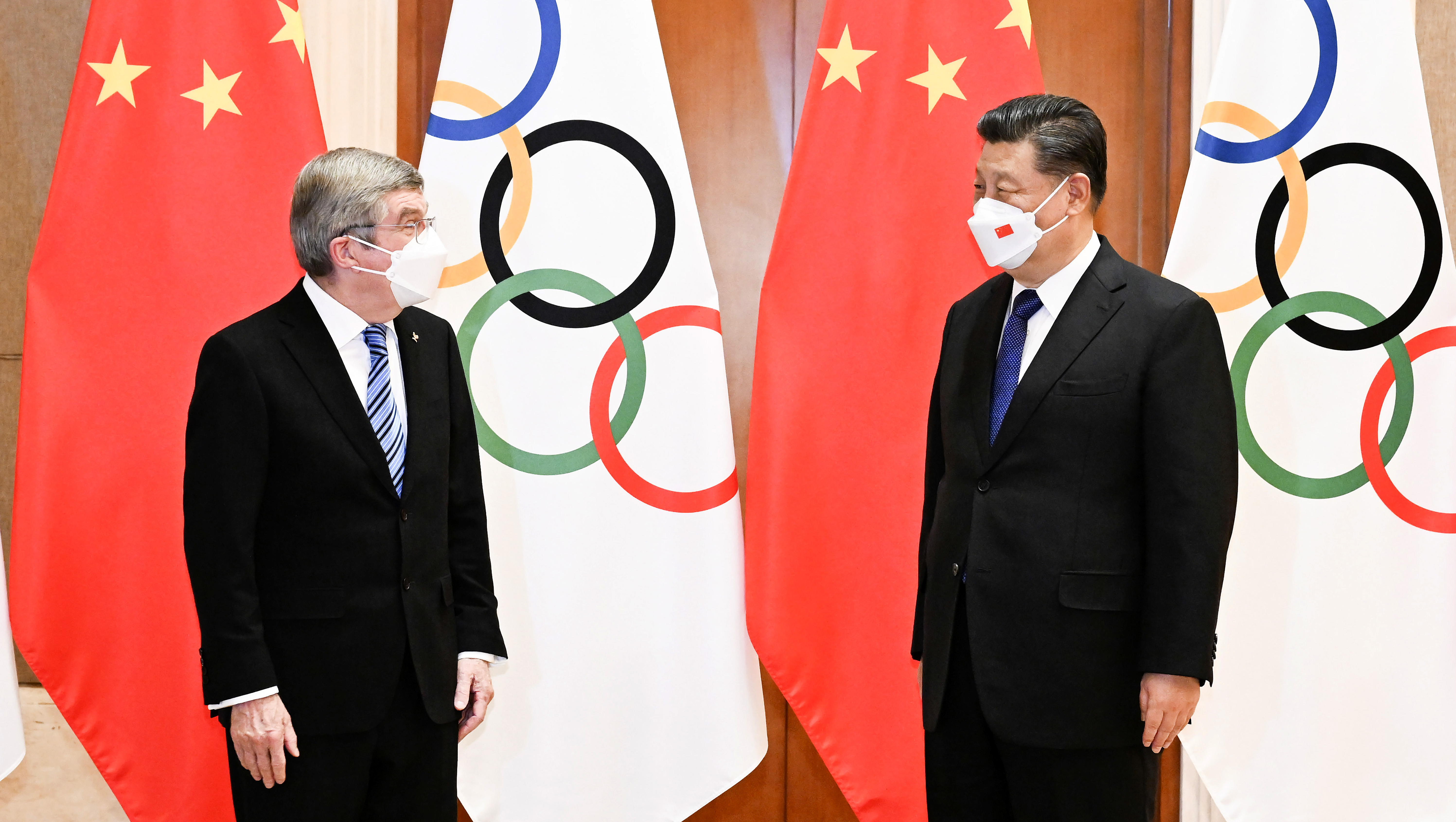 As the Olympics open, China seeks the limelight, but warns against criticism