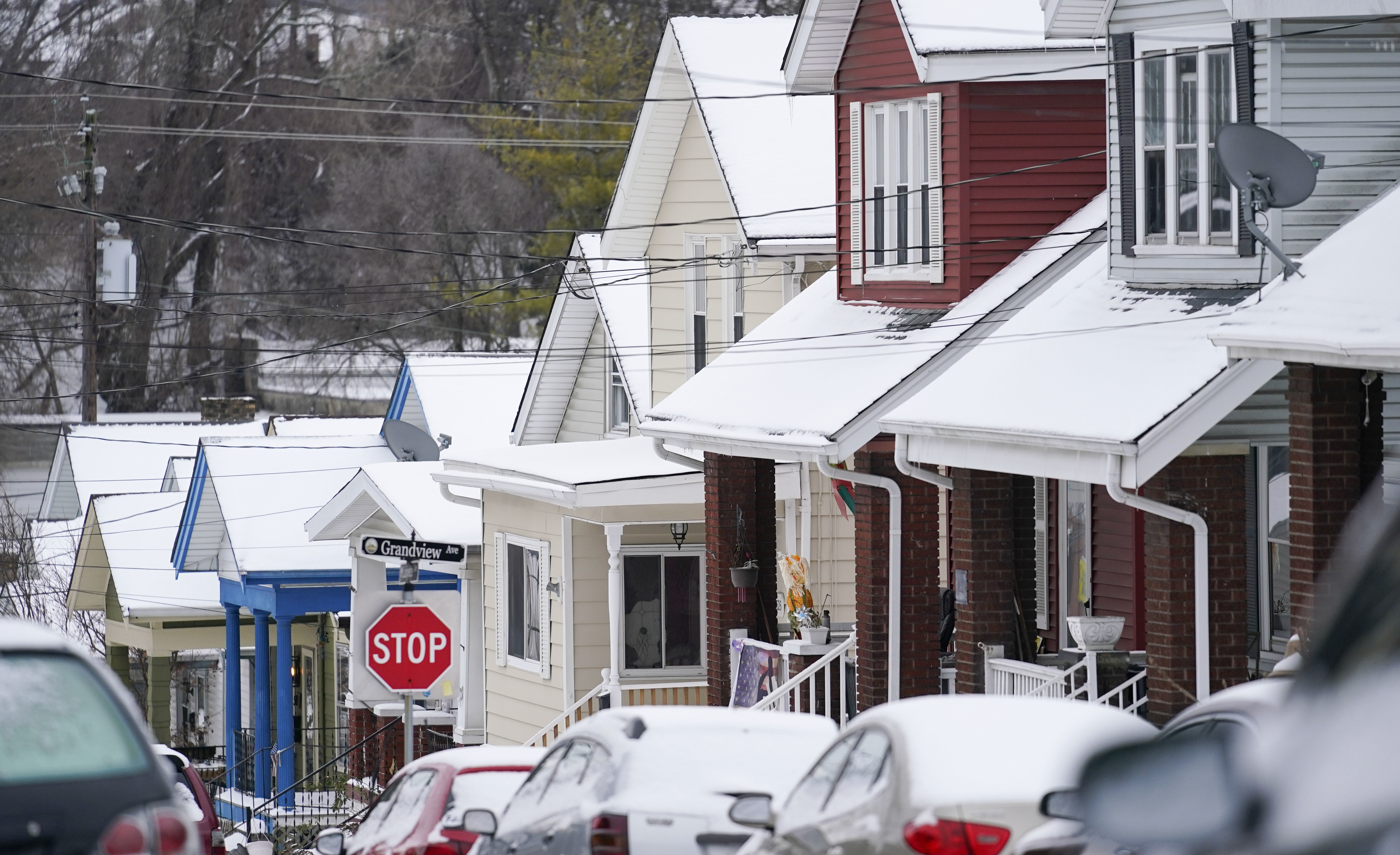 Snow blankets a row of homes after a snowstorm in Bellevue, Ky., on Friday. (NPR)