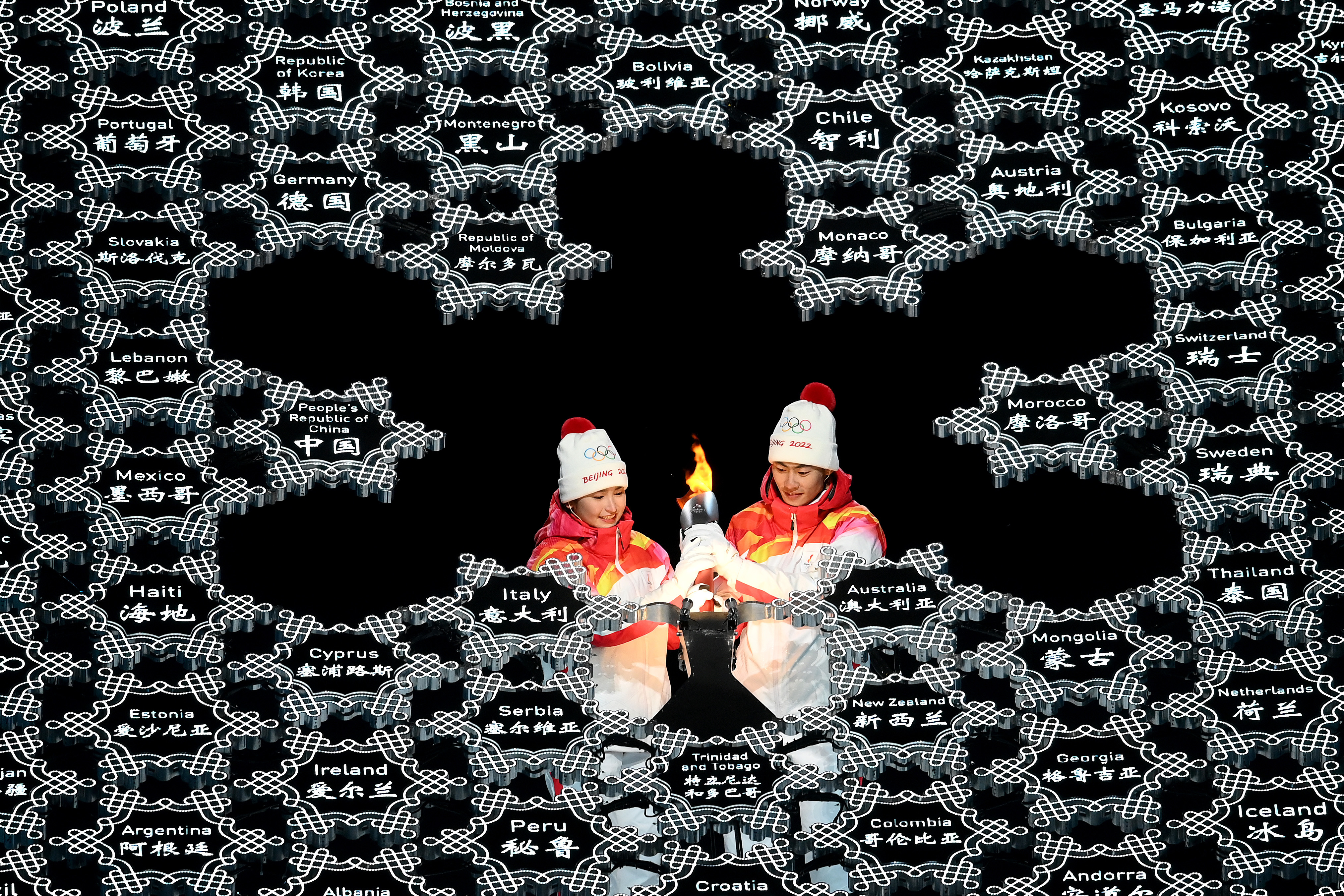 The Winter Games have begun. See photos and highlights from the opening ceremony 18 Torch bearers light the Olympic cauldron during the opening ceremony in Beijing.