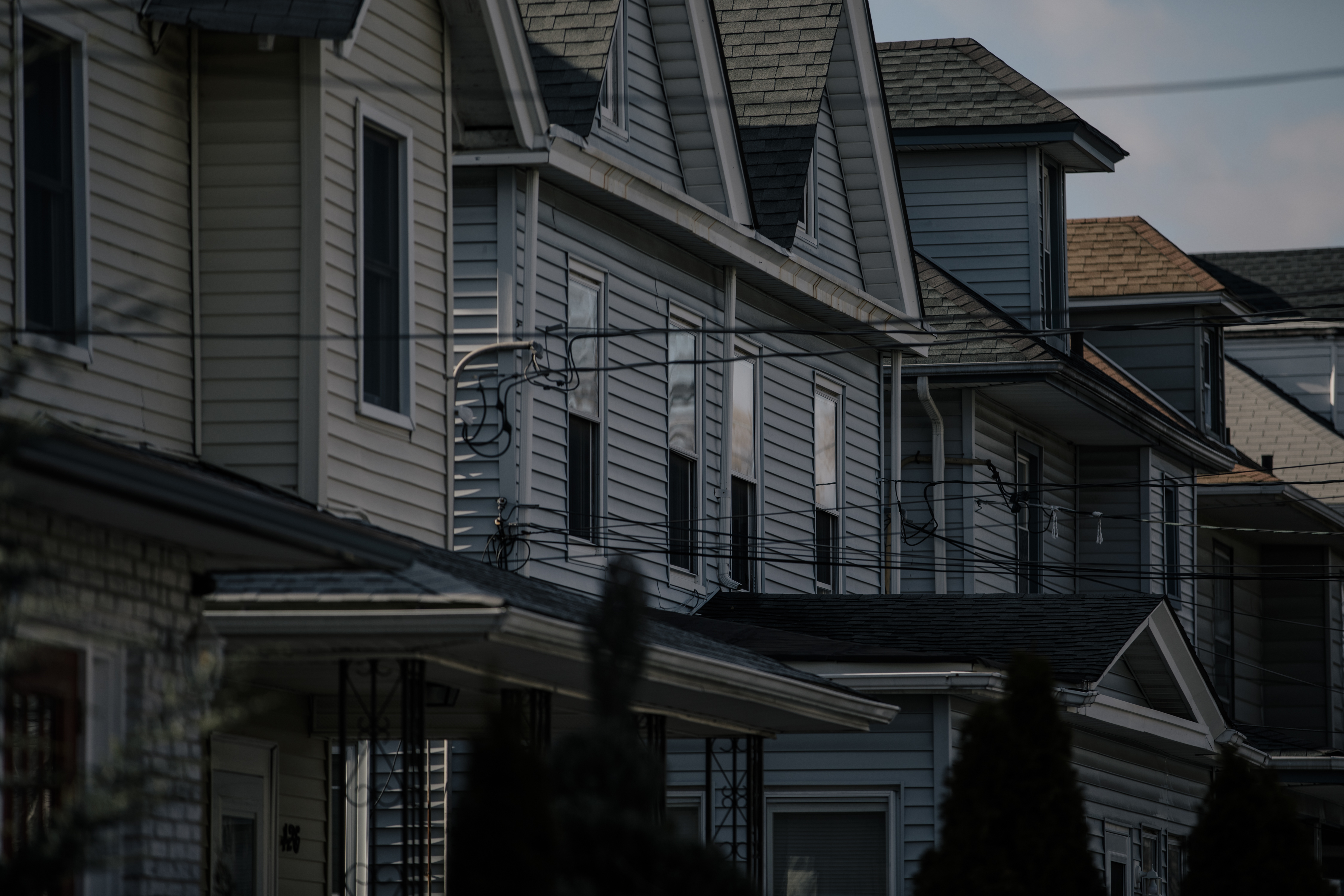 The early February sun hangs over the row of houses in Elizabeth, N.J., outside Simeria Dewalt's home, on Friday, Feb. 5, 2022. (José A. Alvarado Jr. for NPR)