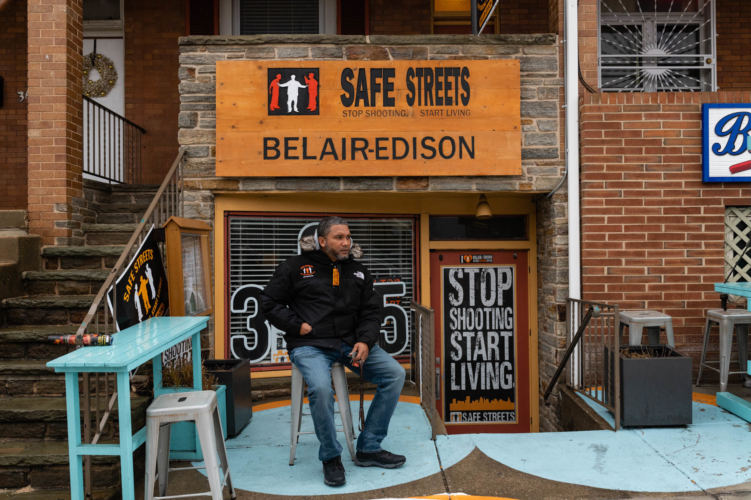 Dante Johnson, director of Safe Streets Belair-Edison, sits outside of their office in Baltimore on Feb. 4. He's a violence interrupter, working to prevent disagreements from escalating. (Eric Lee for NPR)