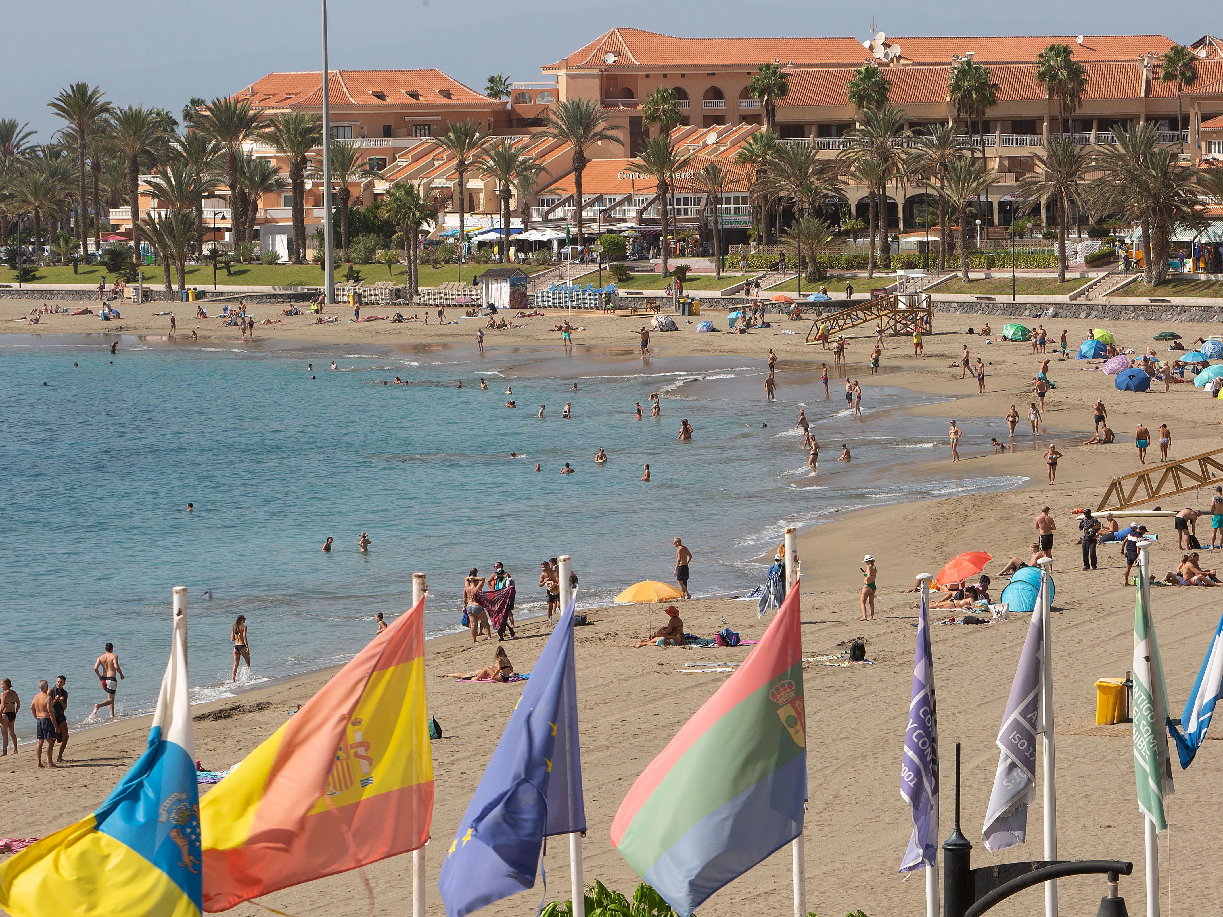 Tourists enjoy a day at the beach on the Canary Island of Tenerife. A Welsh recruitment company is treating its entire staff to a vacation on the island. (AFP via Getty Images)