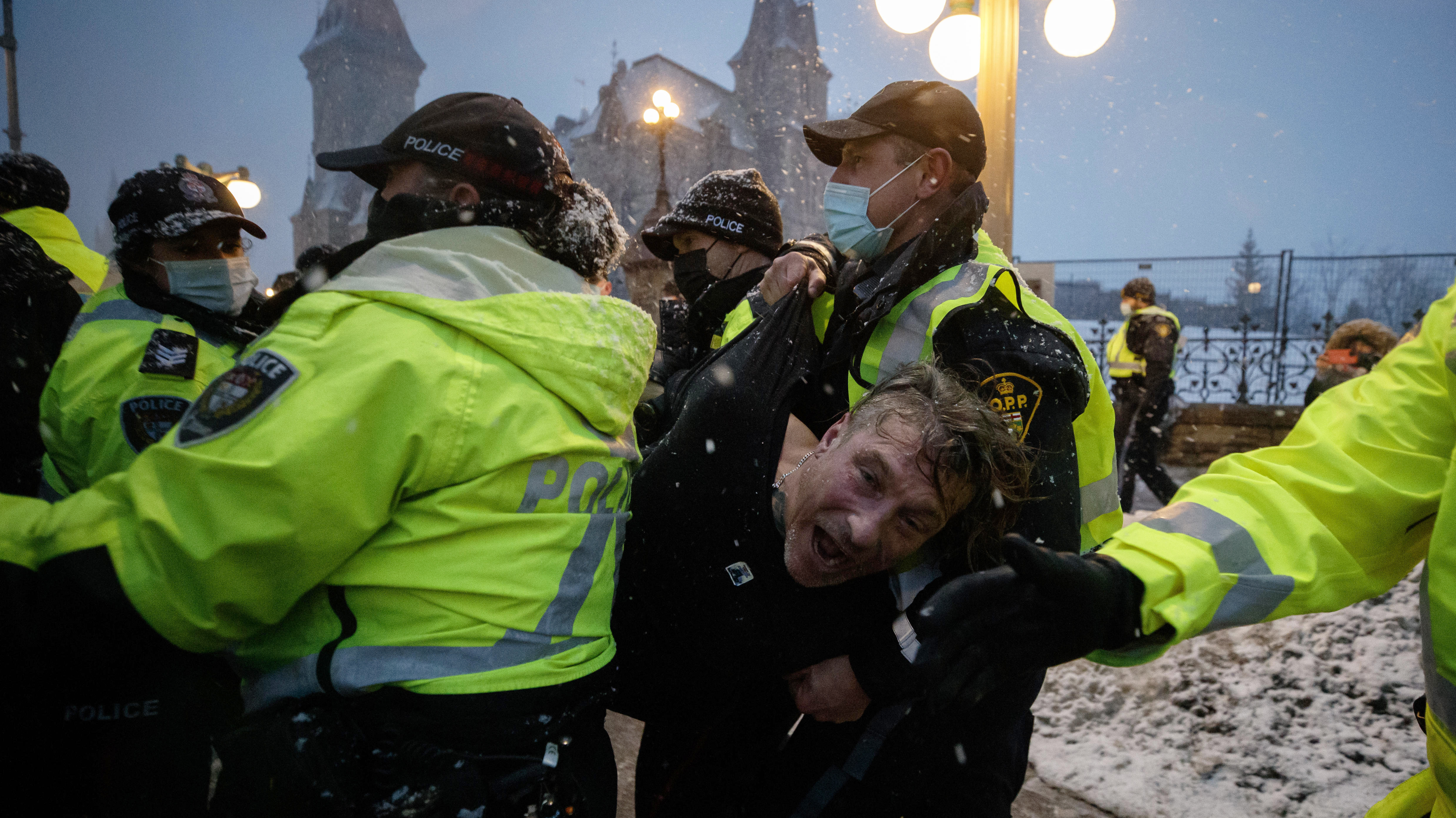 A man is arrested by police in Ottawa on Thursday as demonstrators and supporters gather in a protest against COVID-19 measures that has grown into a broader anti-government protest.
