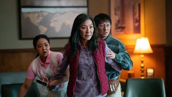 Michelle Yeoh (front), Ke Huy Quan, and Stephanie Hsu in Everything Everywhere All at Once.