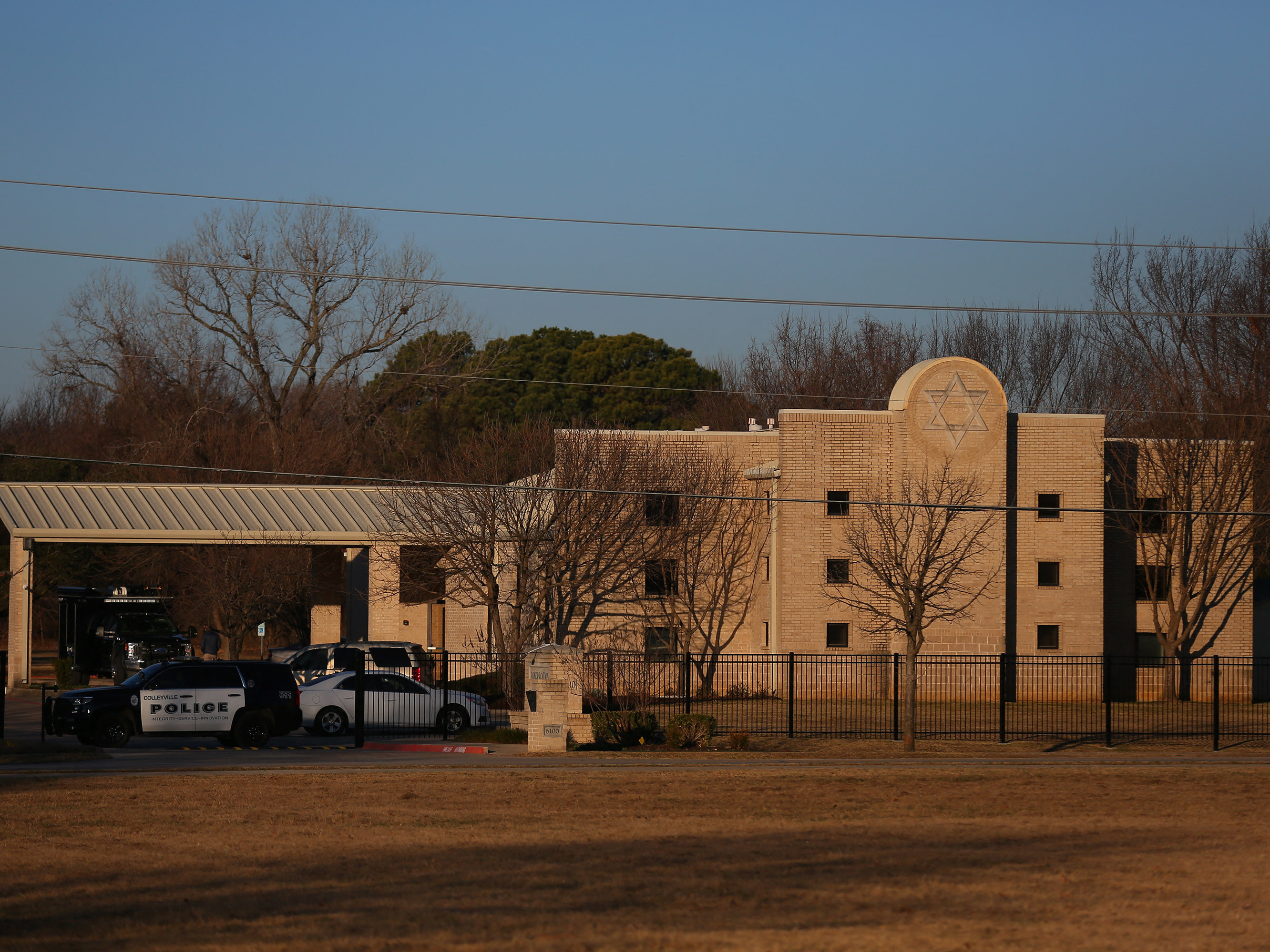 A police vehicle sits in front of Congregation Beth Israel in Colleyville, Texas, on Jan. 16, the day after a gunman took worshippers hostage at the synagogue. Colleyville is among dozens of U.S. cities dealing with the distribution of antisemitic flyers in recent weeks. (AFP via Getty Images)
