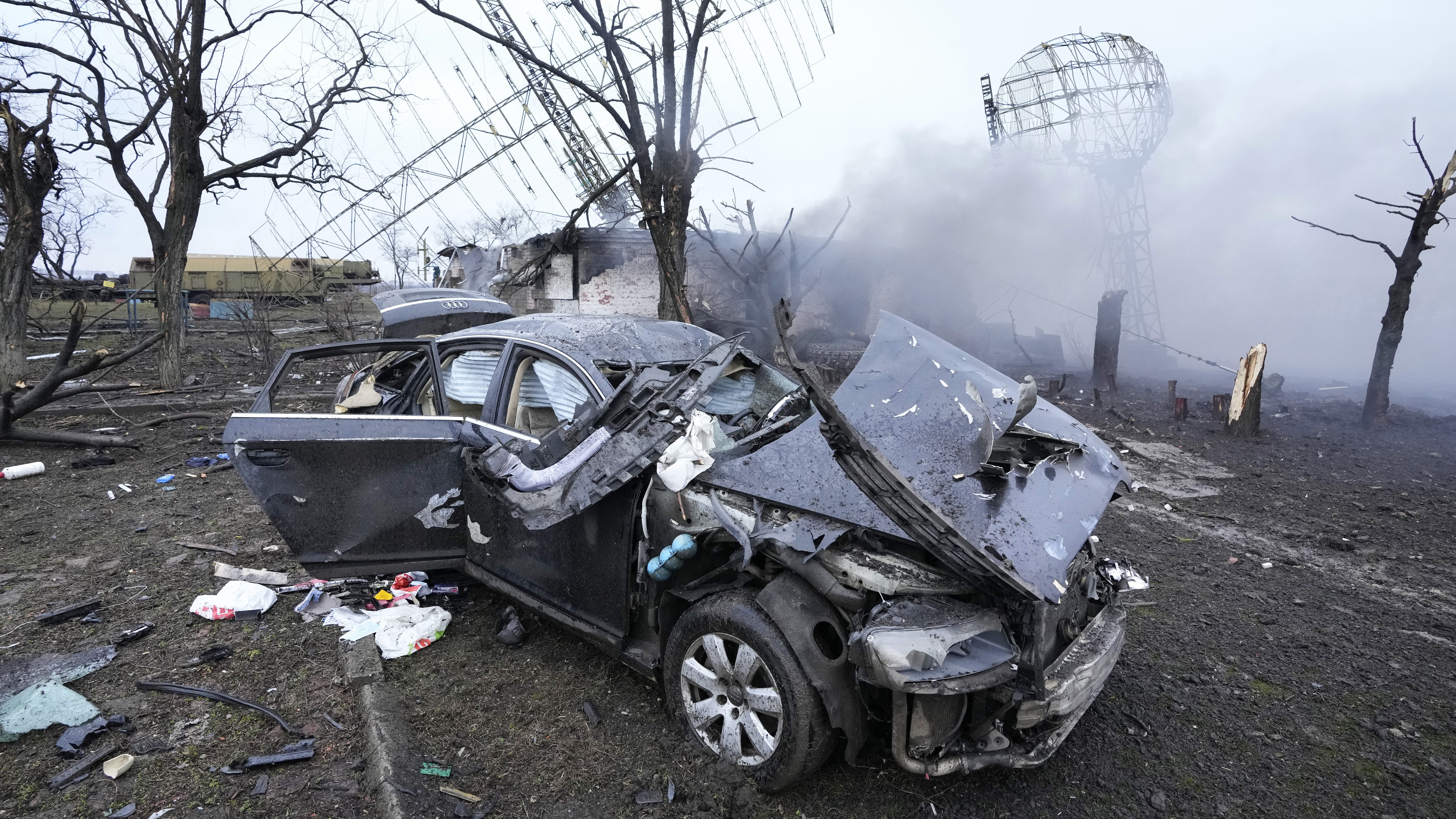 Damaged radar, a vehicle and equipment are seen at a Ukrainian military facility outside Mariupol.
