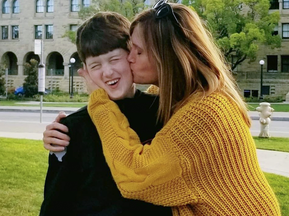 Texas resident Amber Briggle kisses her son. She says the onslaught of anti-trans legislation in the state is emotionally traumatizing. (Amber Briggle)