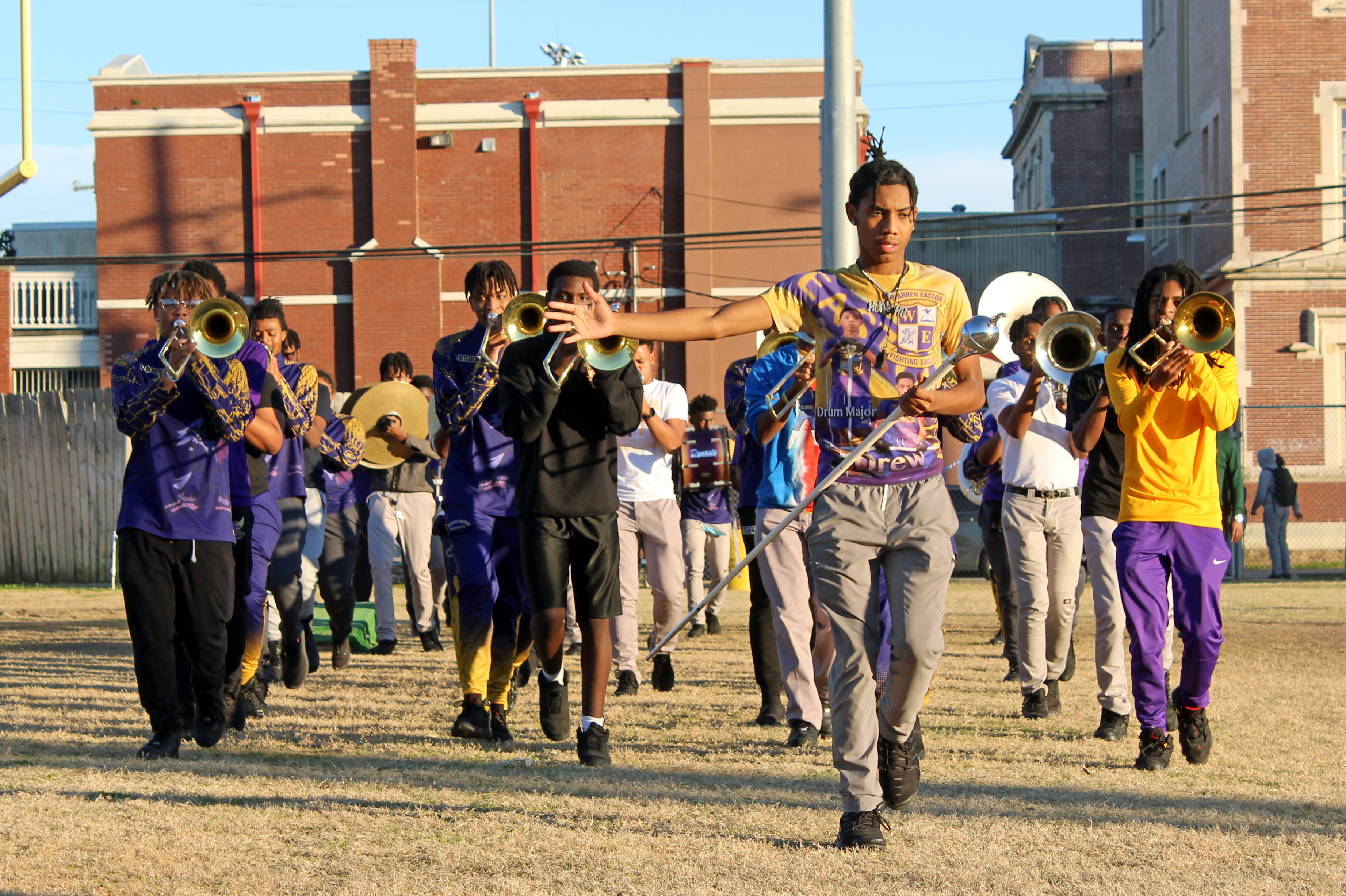 With the return of Mardi Gras marching bands, New Orleans' streets are full of magic 6 Drew Crosby, the drum major at Warren Easton, says that when the crowd is feeling good, he does, too.