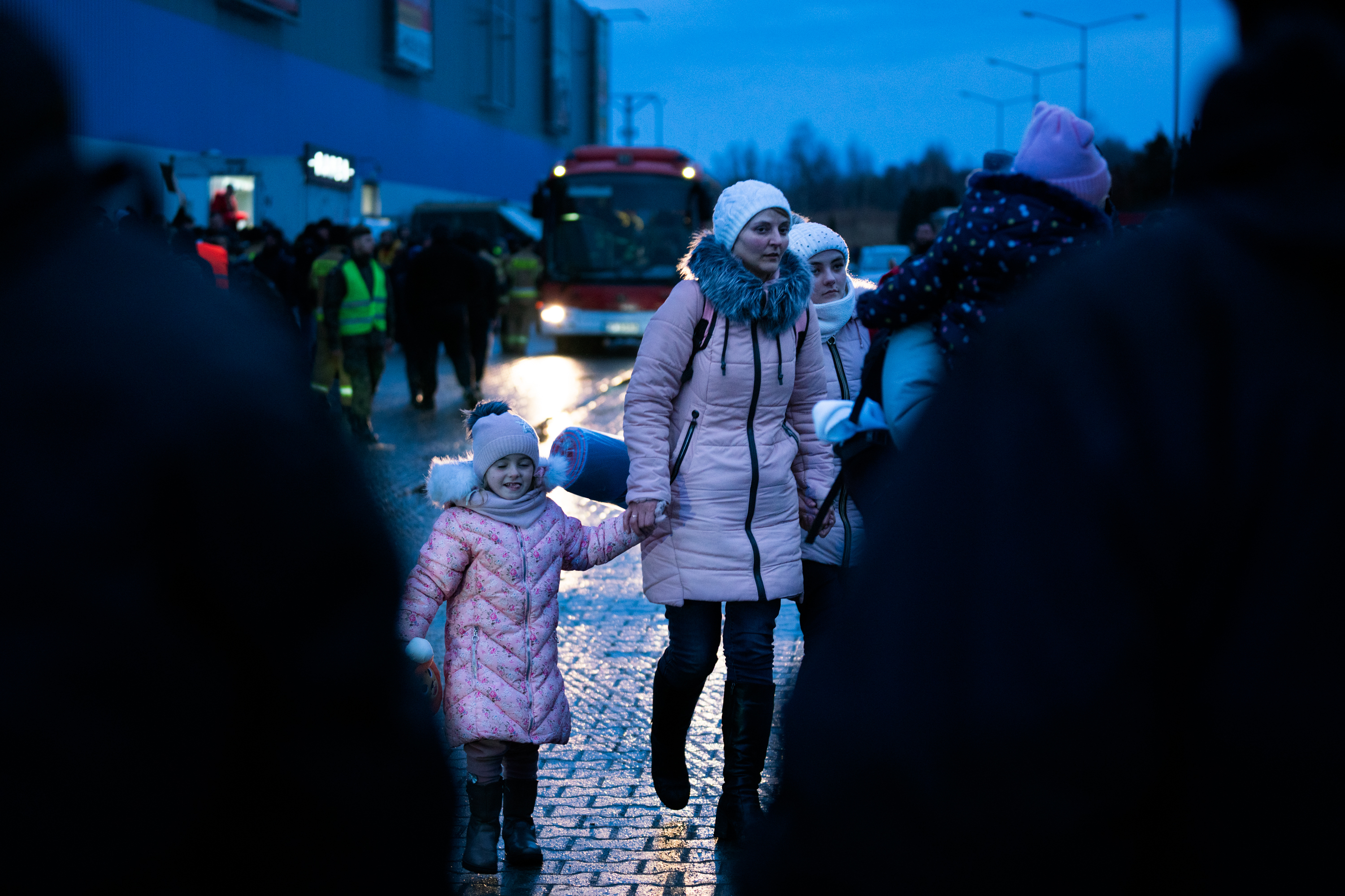 People arrive in Poland who have just crossed the border by bus from Ukraine at the Korczowa-Krakovets crossing. (NPR)