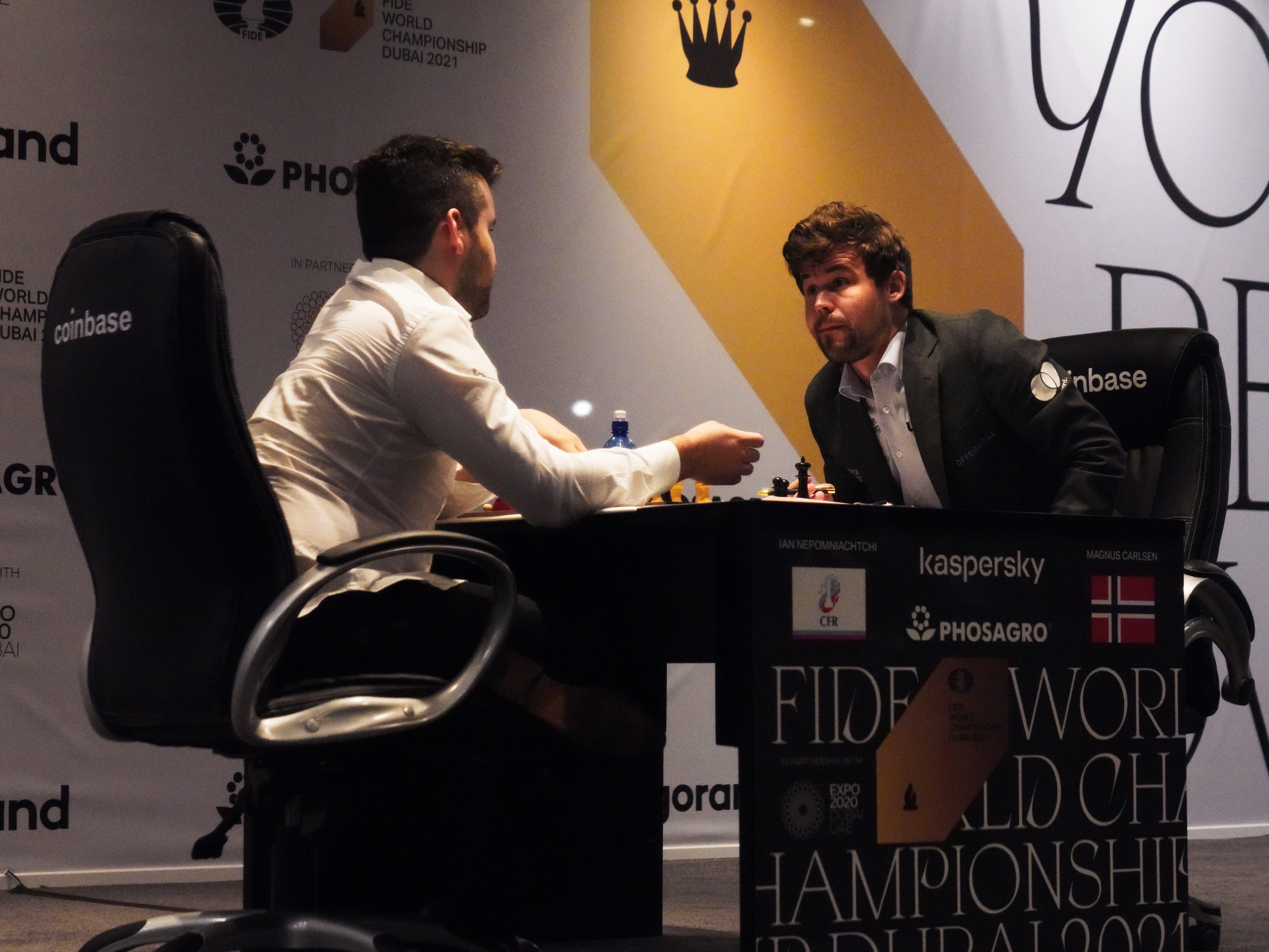 Ian Nepomniachtchi of Russia (left) and Magnus Carlsen of Norway talk after Carlsen won the FIDE World Championship in 2021. FIDE has banned competitions in Russia and Belarus in response to Russia's invasion of Ukraine. (AP)