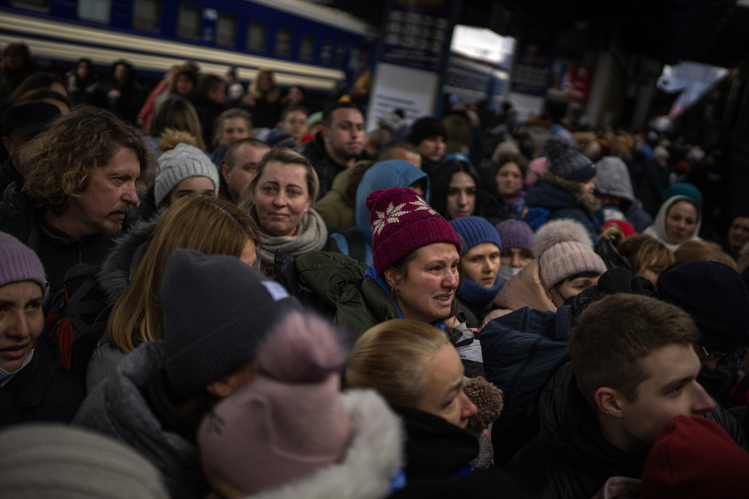 Women and children try to get onto a train bound for Lviv, Ukraine, at Kyiv's train station Thursday, March 3. Ukrainian men have been conscripted to fight in the war while hundreds of thousands of women and children flee the country to seek refuge in neighboring nations that are members of the EU.