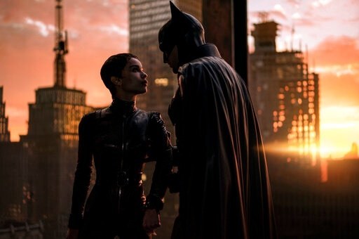 This image released by Warner Bros. Pictures shows Zoe Kravitz, left, and Robert Pattinson in a scene from &quot;The Batman.&quot; (Warner Bros.)