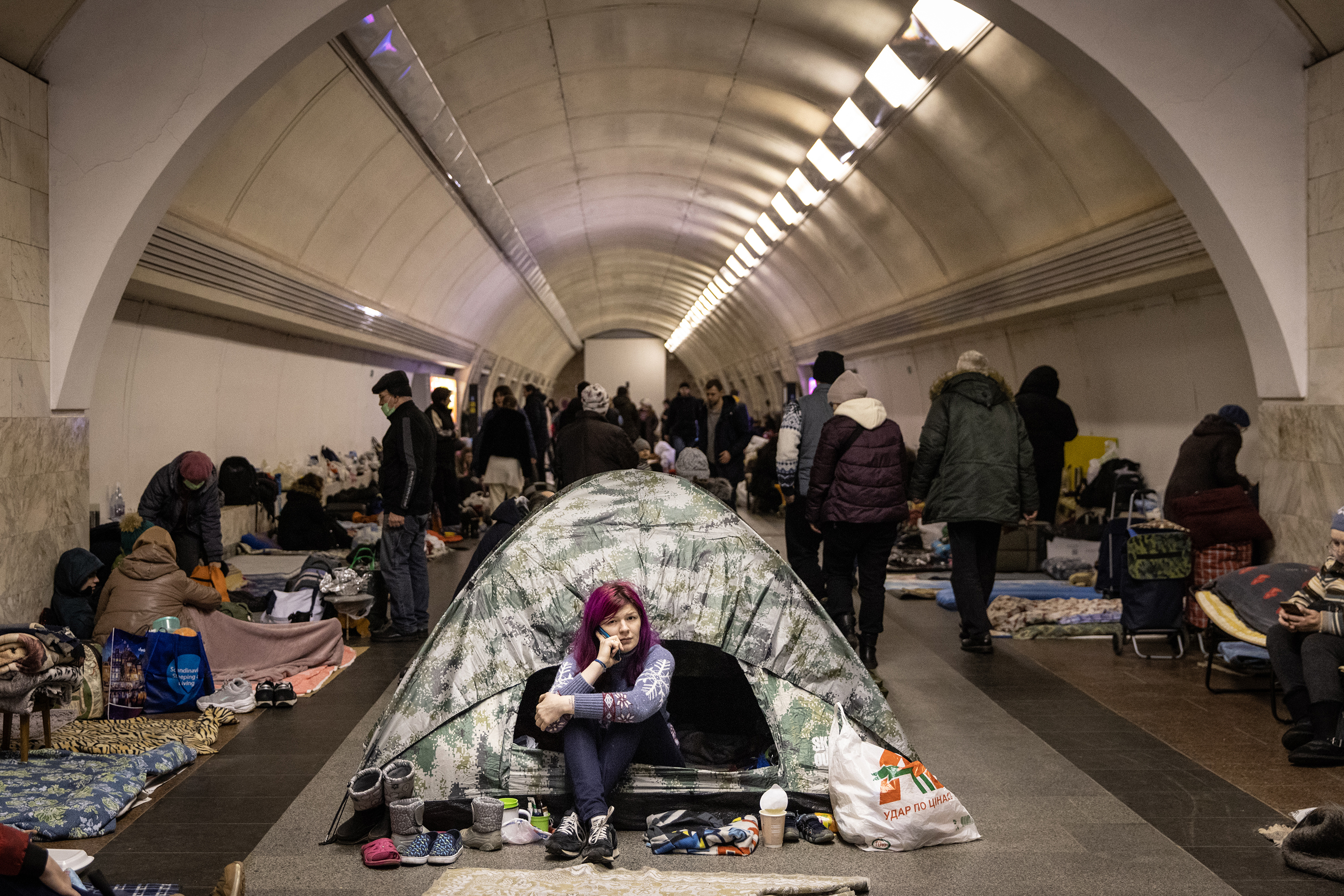 A woman sits in a tent as people take shelter in a subway station turned into a bomb shelter Wednesday, March 2, in Kyiv, Ukraine.