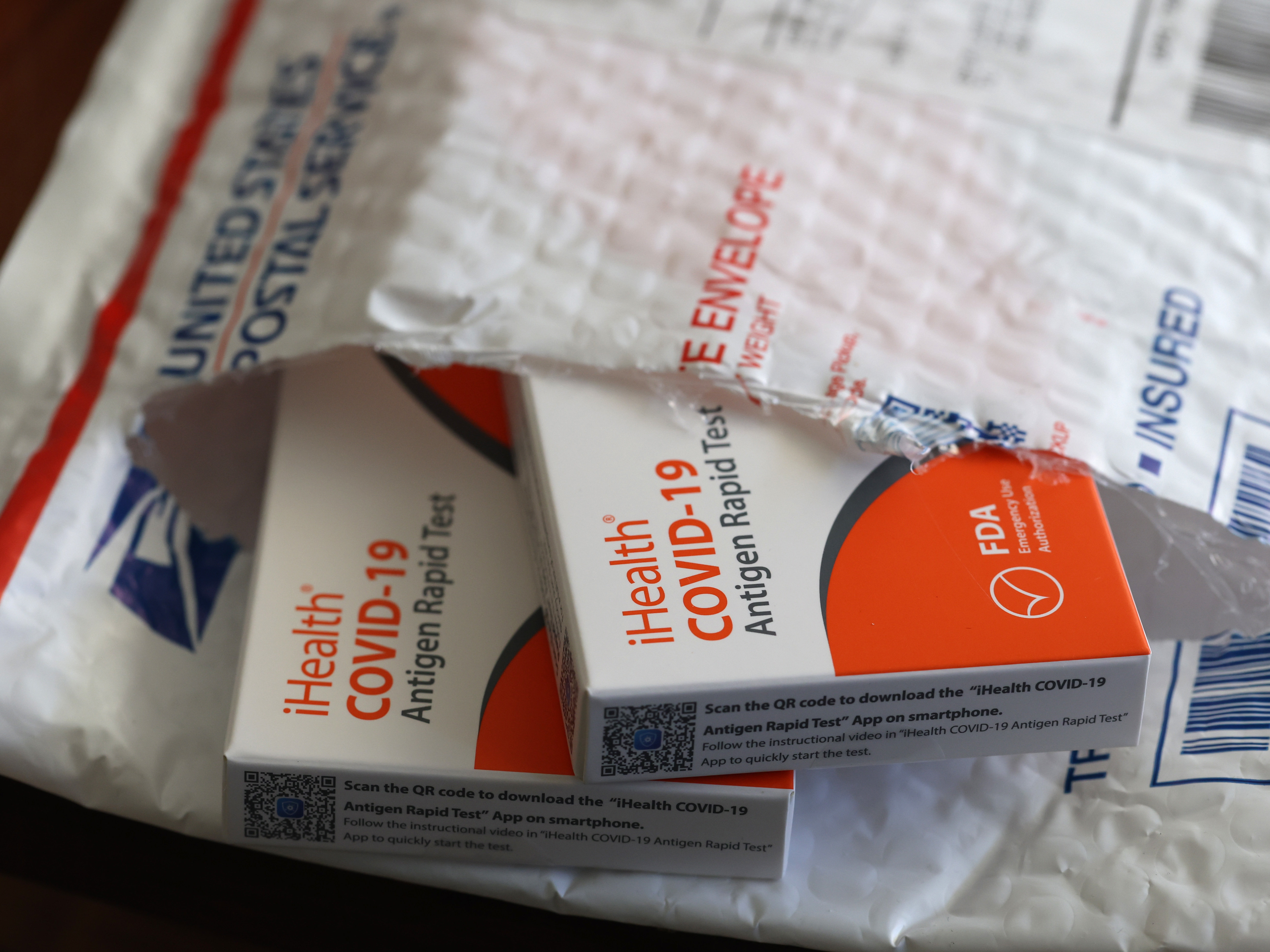 In this photo illustration, free iHealth coronavirus rapid tests from the federal government sit in a U.S. Postal Service envelope after being delivered on Feb. 4. (Getty Images)