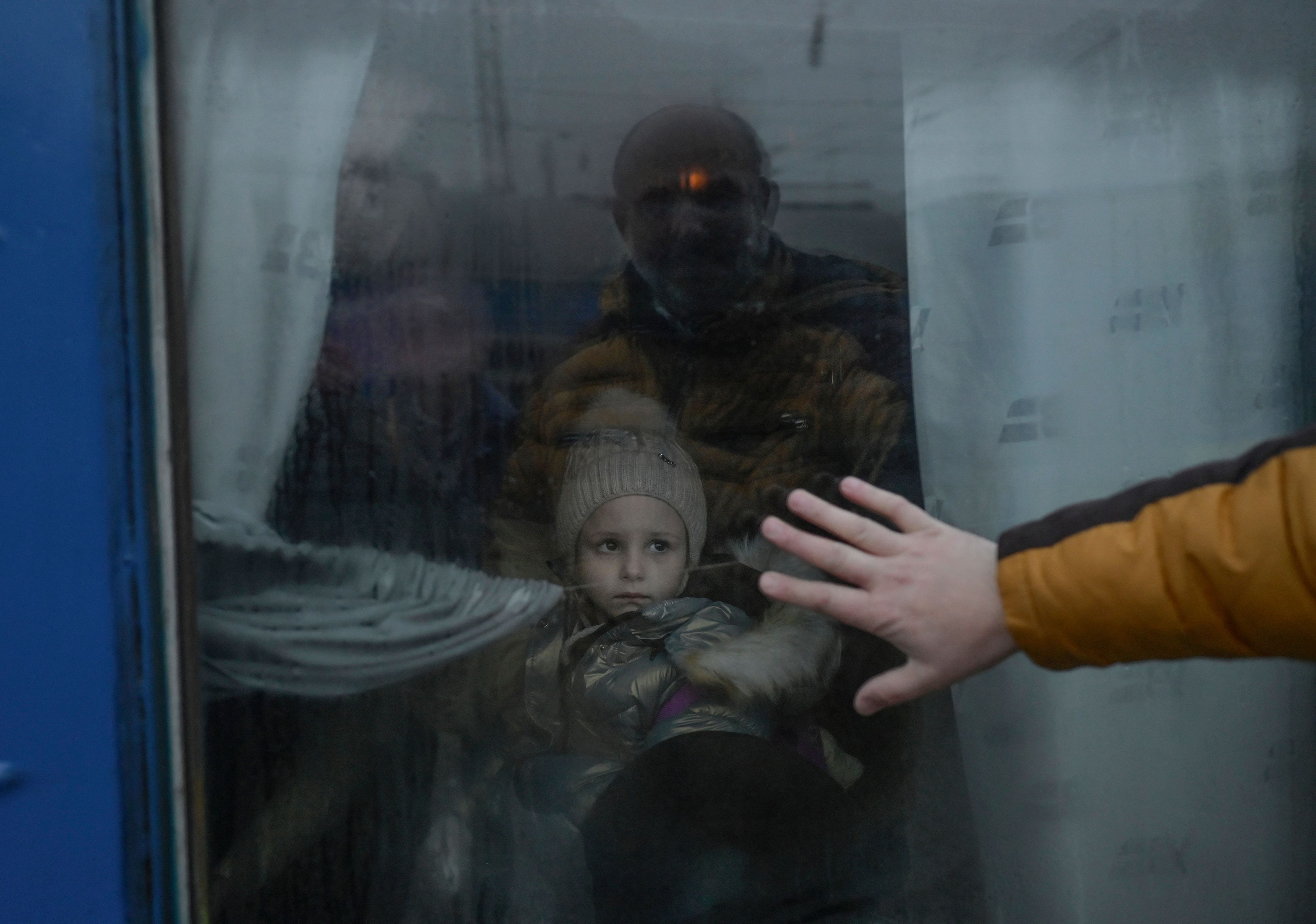 March 7: A father puts his hand on the window of an evacuation train as he says goodbye to his daughter at the central train station in Odesa. The city is the site of Ukraine's main port, which is vital to the country's economy.