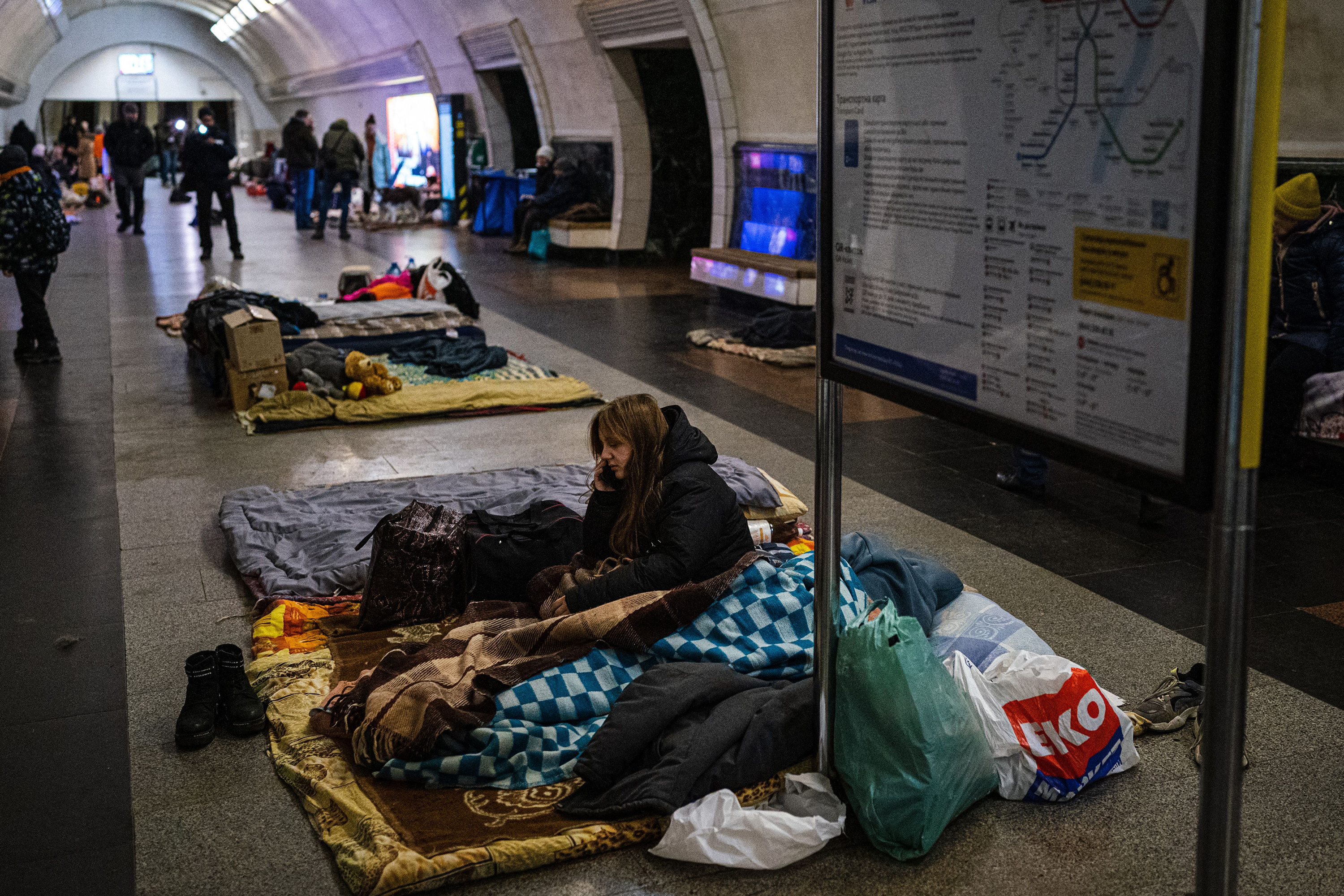 March 8: A woman makes a call to relatives in an underground metro station being used as a bomb shelter in Kyiv.