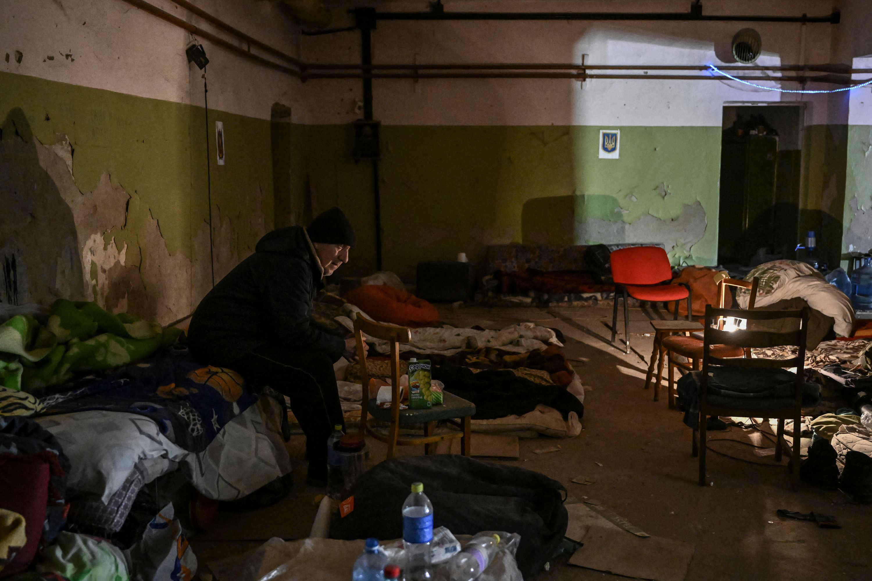March 10: A resident sits in a basement for shelter in Irpin. Kyiv's northwest suburbs, including Irpin and Bucha, have endured shellfire and bombardments for more than a week, prompting massive evacuation efforts.