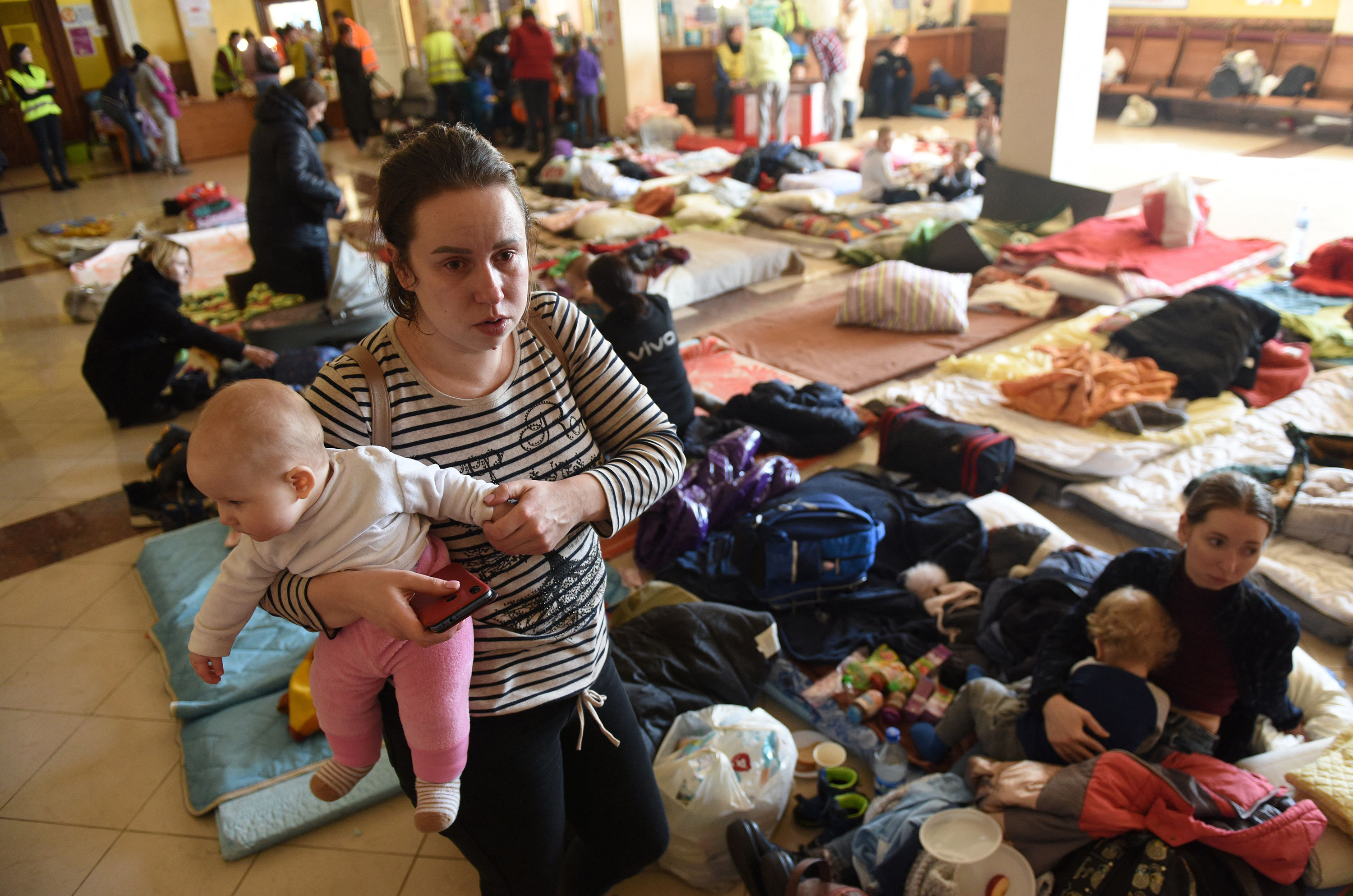 March 11: Women with small children fleeing the invasion settle in at the Lviv, Ukraine, train station.