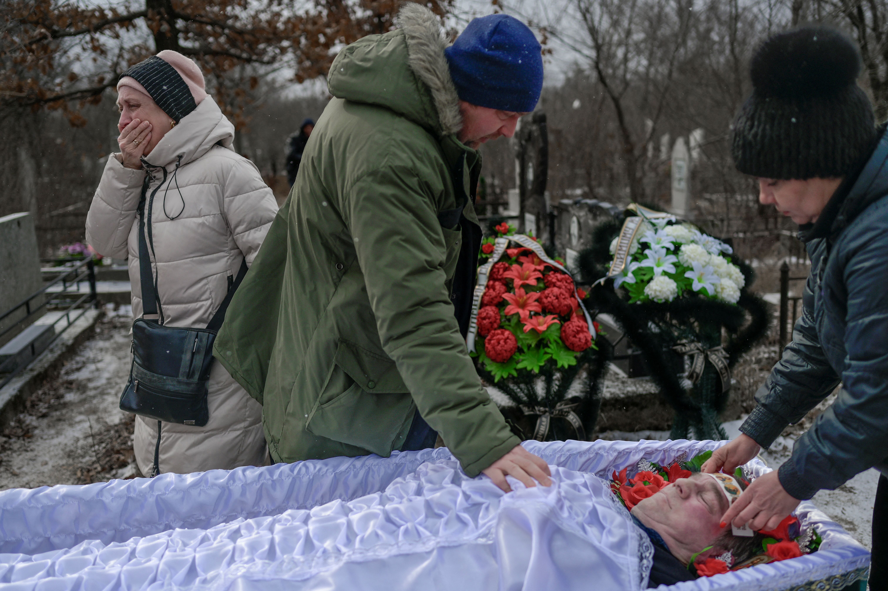 March 11: Mourns pay their last respects as a woman (L) grieves during the funeral of a man killed in shelling at a cemetery in Mykolaiv, a city on the shores of the Black Sea that has been under Russian attack for days.