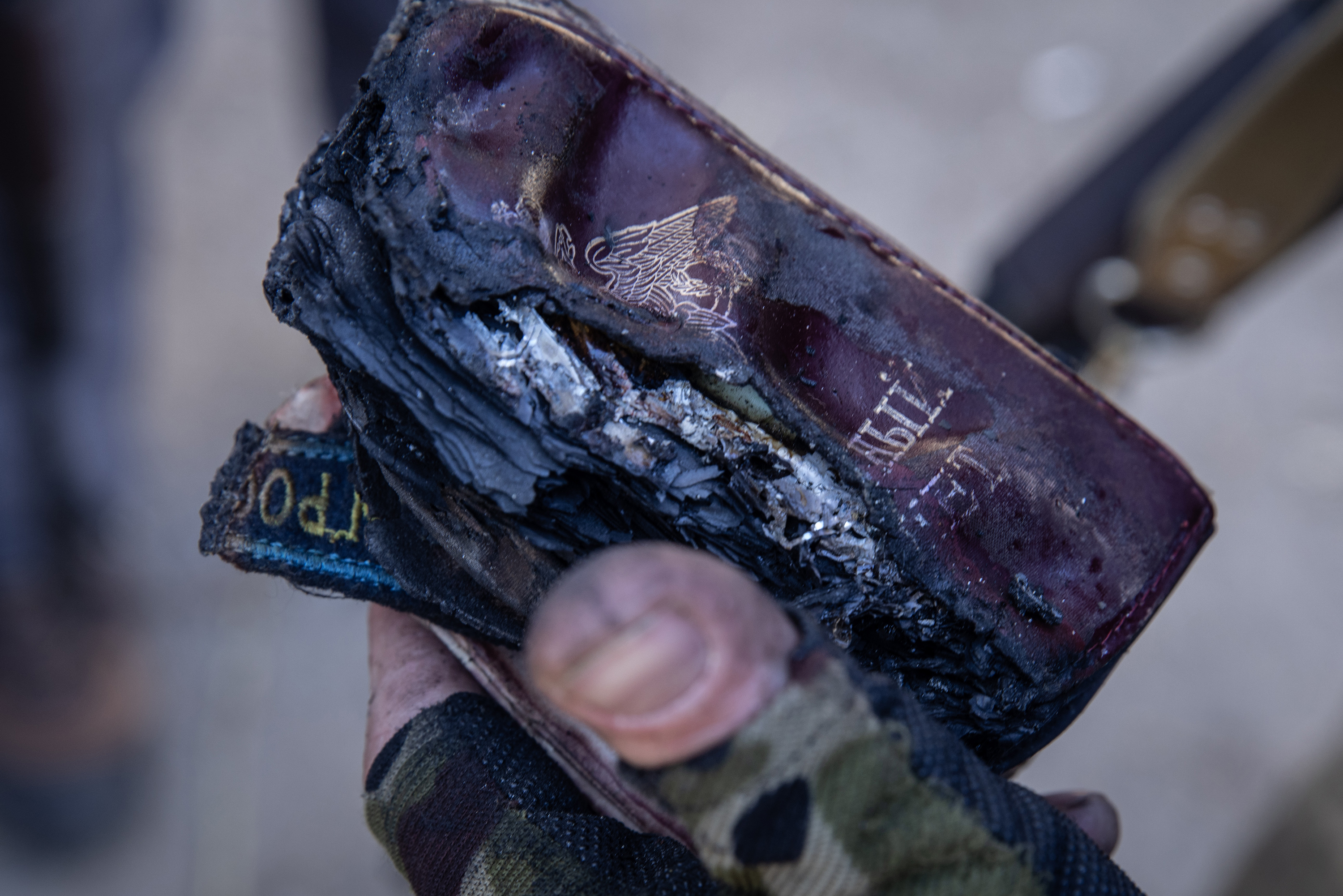 March 10: A member of the Ukrainian military holds the burnt remains of Russian passports in Irpin, Ukraine.