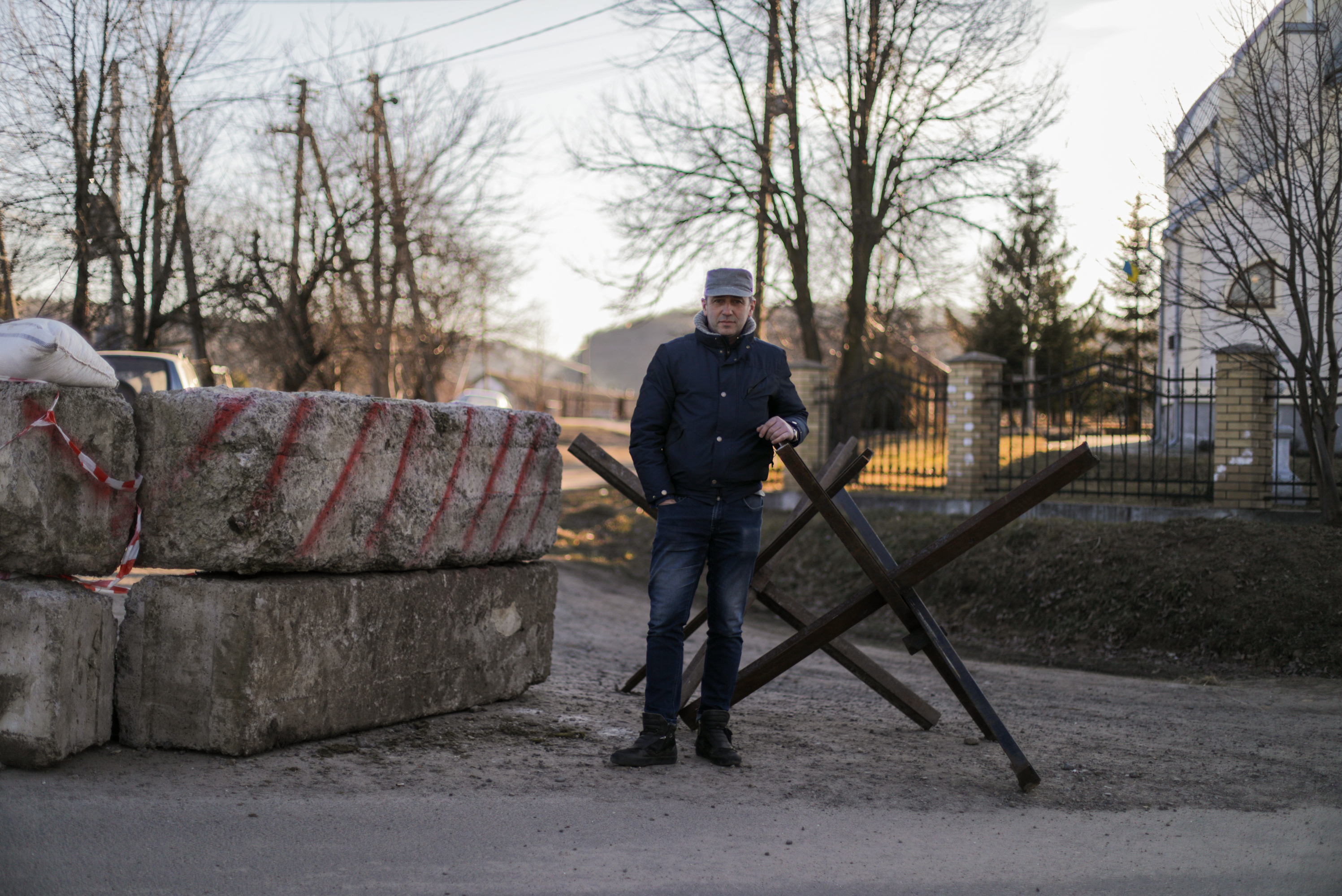 Oleh Pokrovsky helps man a small checkpoint on a bumpy road leading to his village. &quot;The privilege that we have of sitting here at this checkpoint is thanks directly to those who are enlisted in the military and are defending Ukraine's borders,&quot; he says. &quot;If it weren't for them, then this would be under Russian occupation right now.&quot; (NPR)