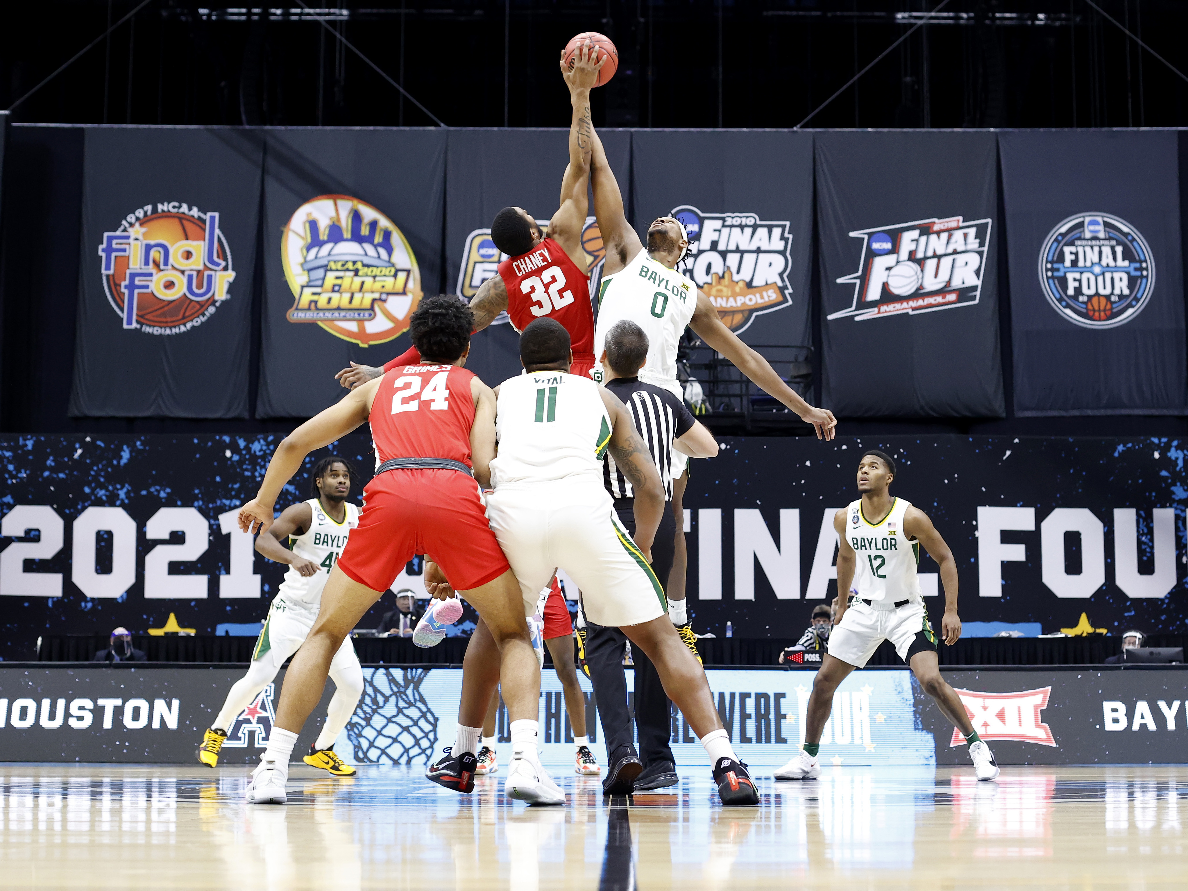 For the first time in the history of the March Madness tournament, NCAA athletes will be able to profit off their names, images and likenesses. Above, Reggie Chaney of the Houston Cougars and Flo Thamba of the Baylor Bears compete for the opening tipoff during the 2021 tournament. (Getty Images)