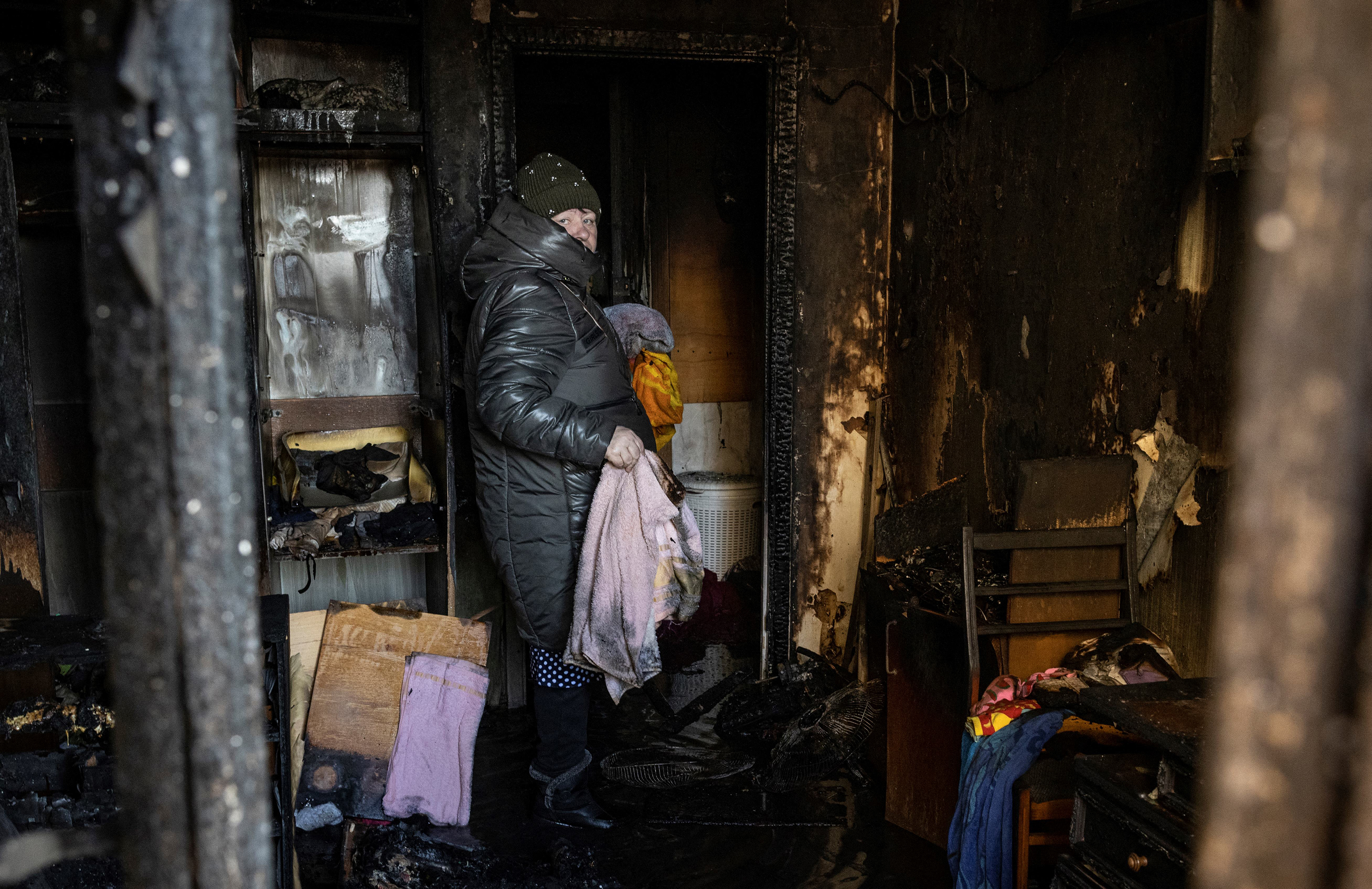 March 15: A resident stands in her Kyiv, Ukraine, apartment after it was damaged by Russian shelling that killed at least two people.