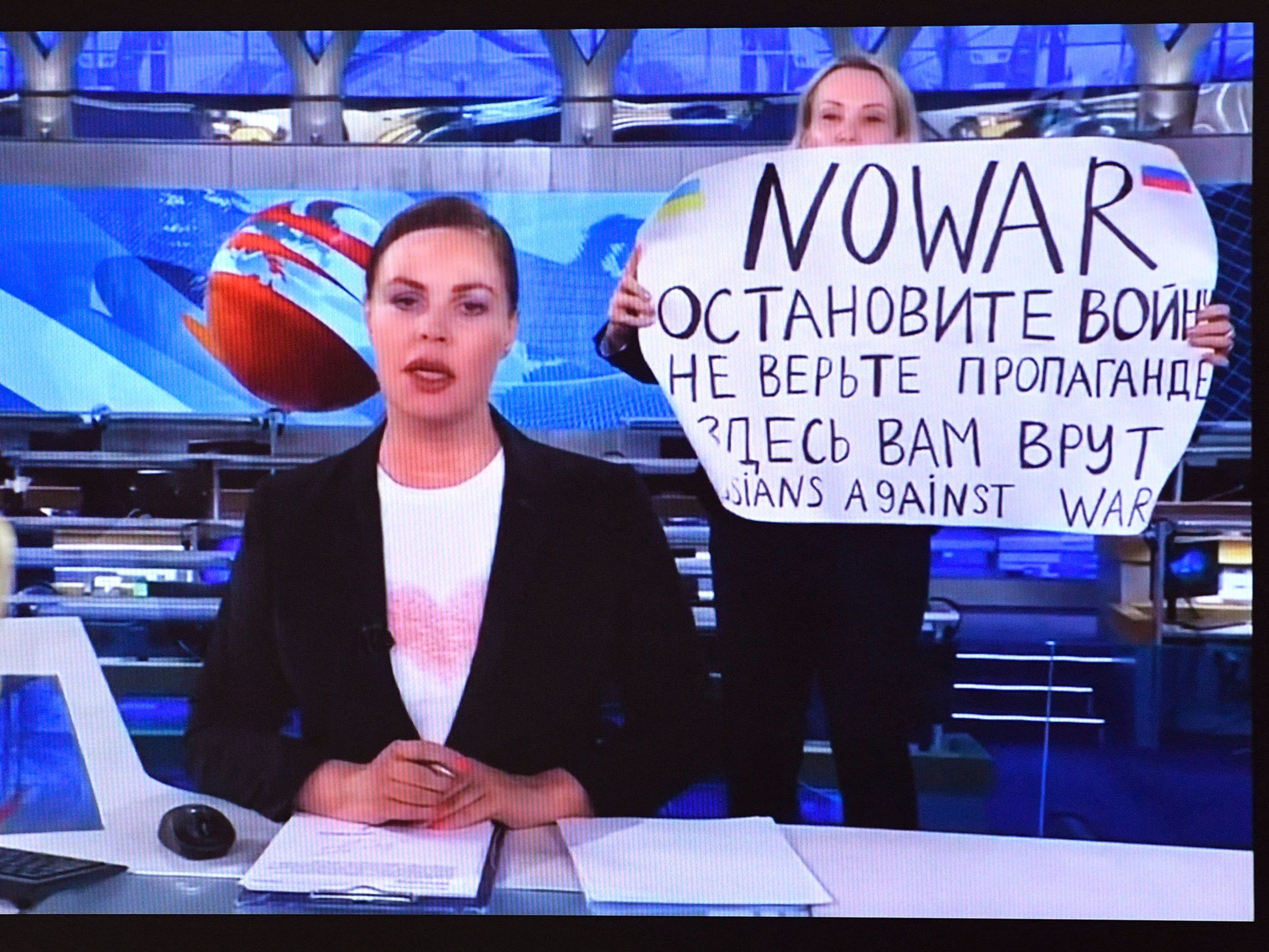 A dissenting Channel One employee interrupted Russia's most-watched evening news broadcast, holding a poster reading &quot;No War&quot; and &quot;Russians against war&quot; and condemning Moscow's military action in Ukraine. (AFP via Getty Images)