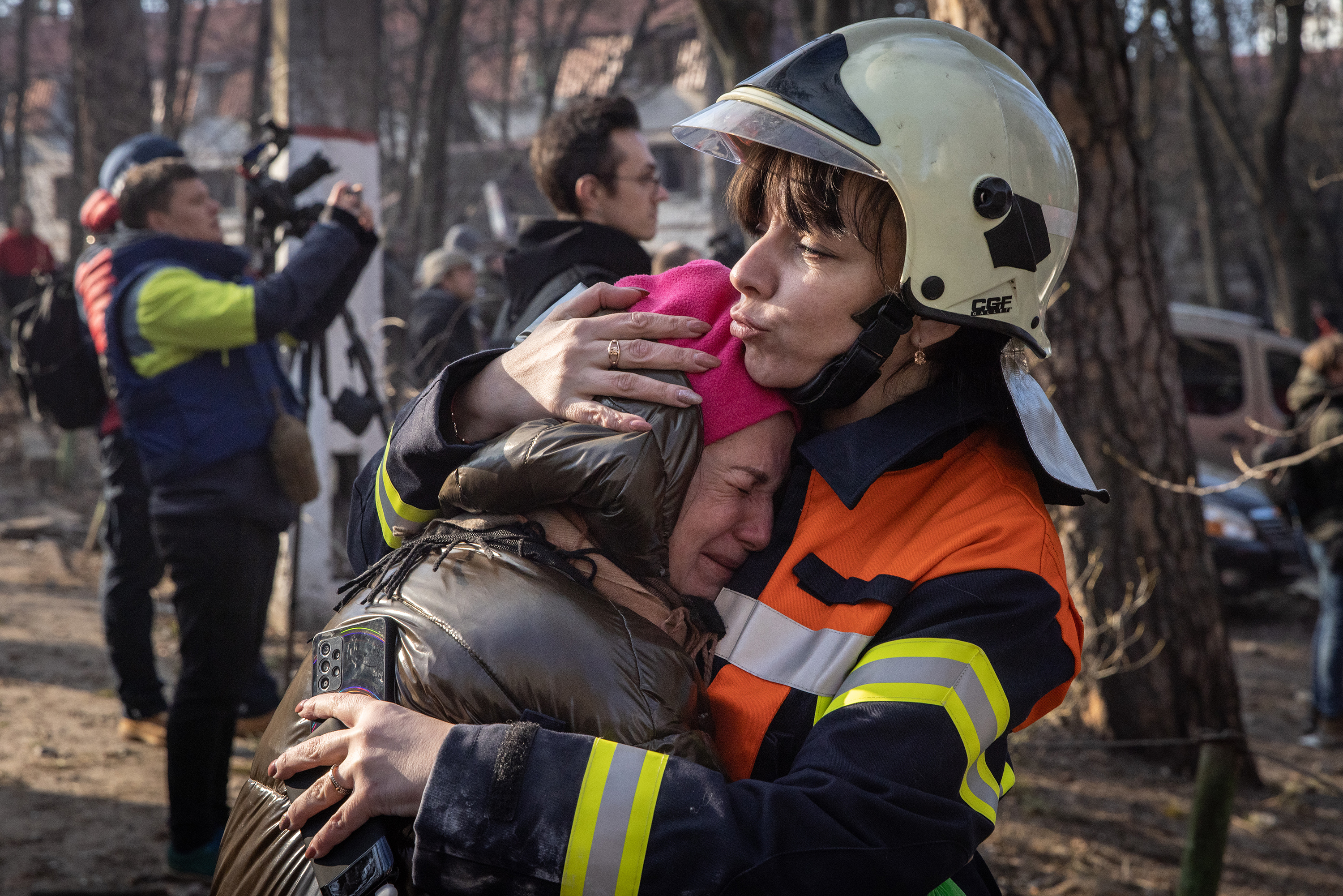 March 15: A resident is comforted by an emergency services worker at a residential apartment building in the Sviatoshynskyi District of Kyiv, Ukraine, after it was hit by a Russian attack in the early morning hours Tuesday.