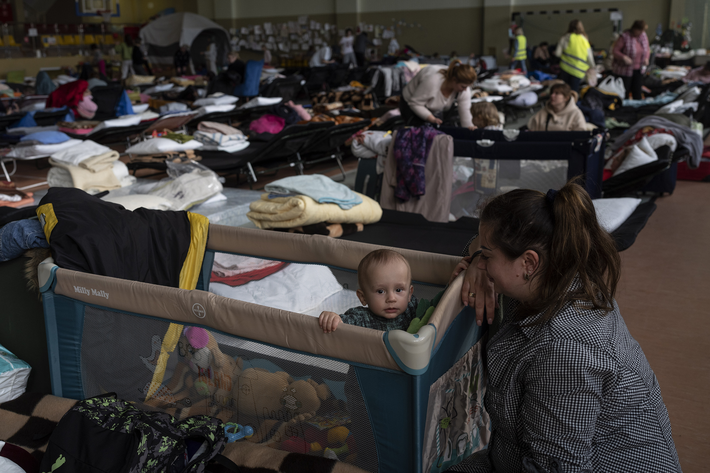 March 15: Natasha looks after her 1-year-old son, Vlad, inside an indoor sports stadium being used as a refugee center near the Ukraine border in the village of Medyka, Poland.