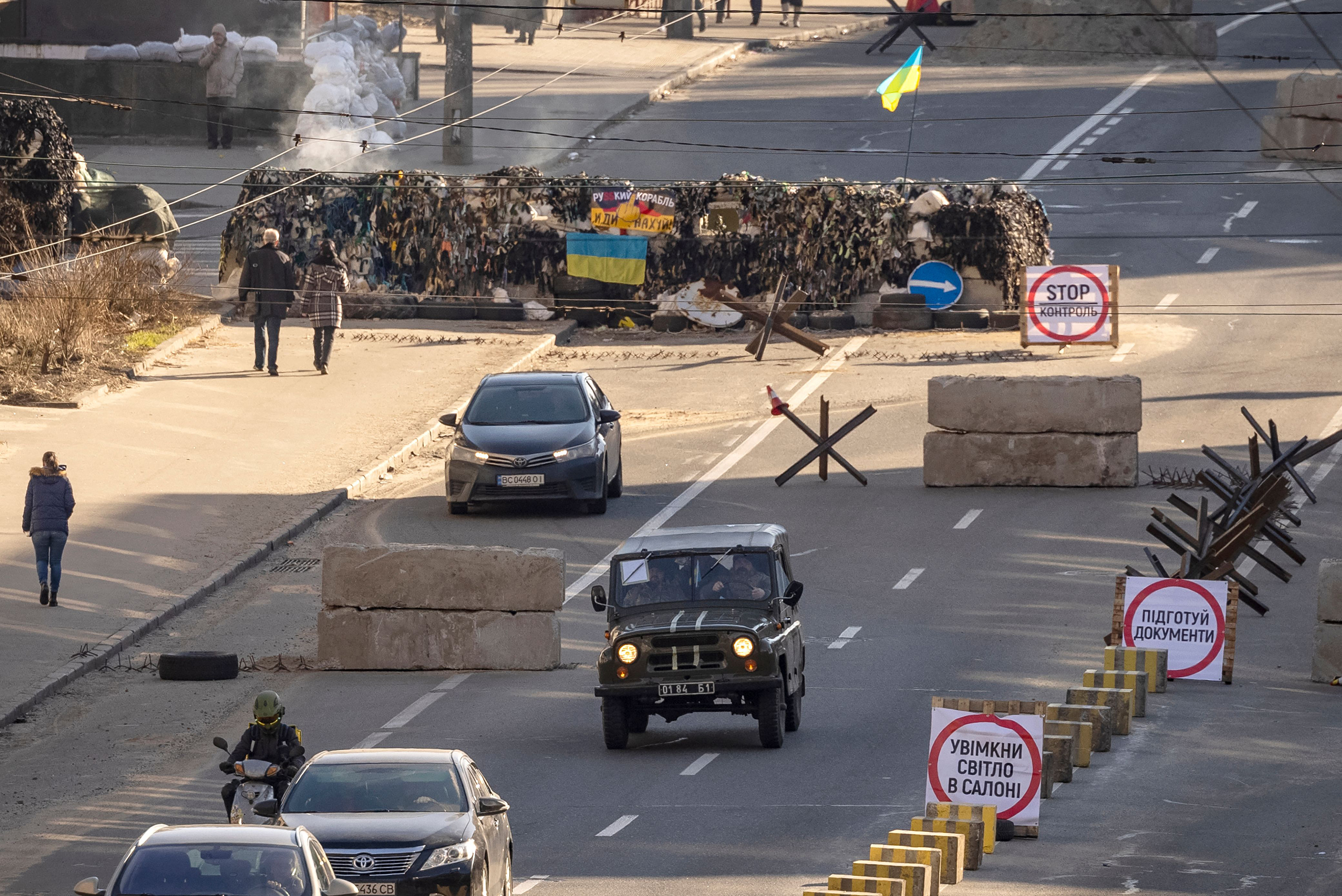 March 15: A car rides away from a Ukrainian military check point in the center of Kyiv on the 20th day of the Russian invasion.