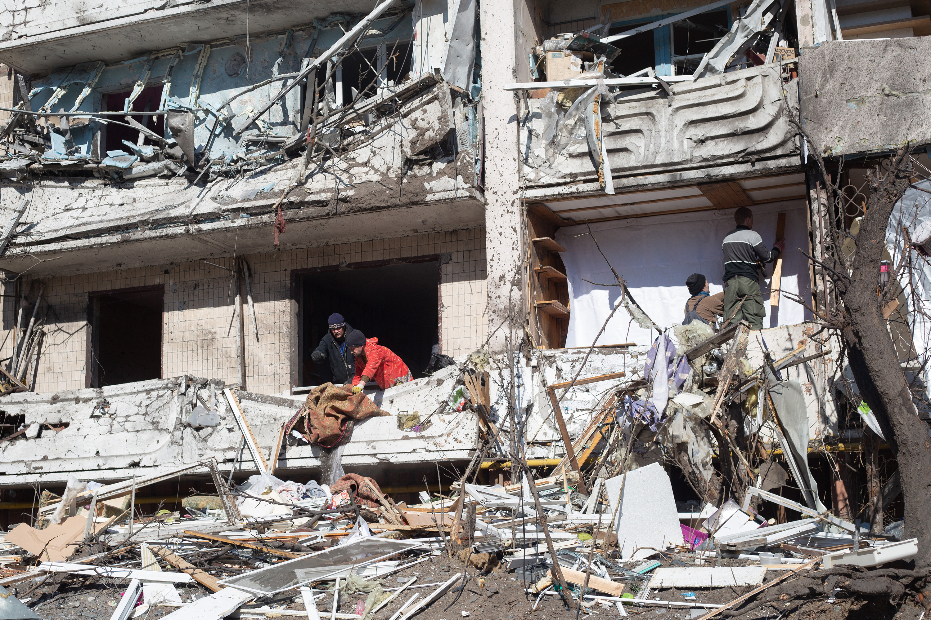 March 15: Ukrainians sort through the debris after a residential building in Kyiv was hit by a rocket.