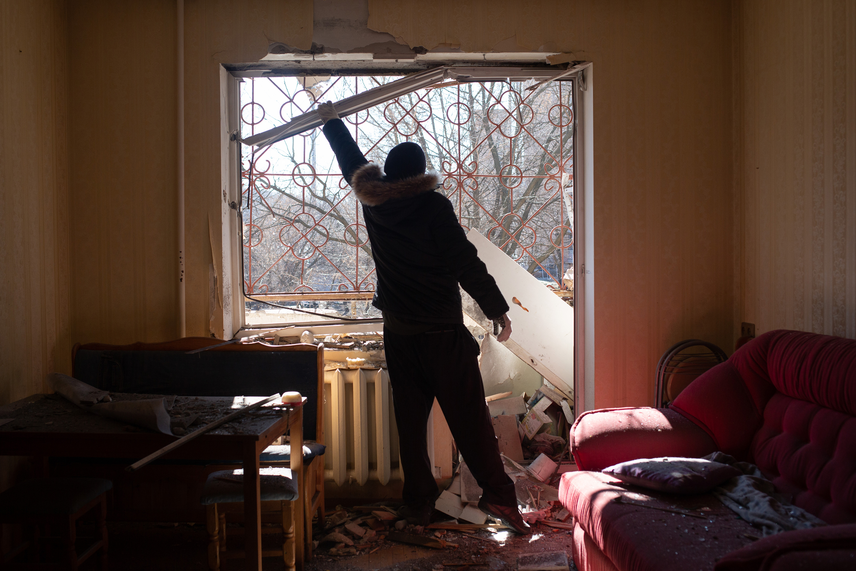 March 15: A man removes the rubble from his flat in Kyiv.