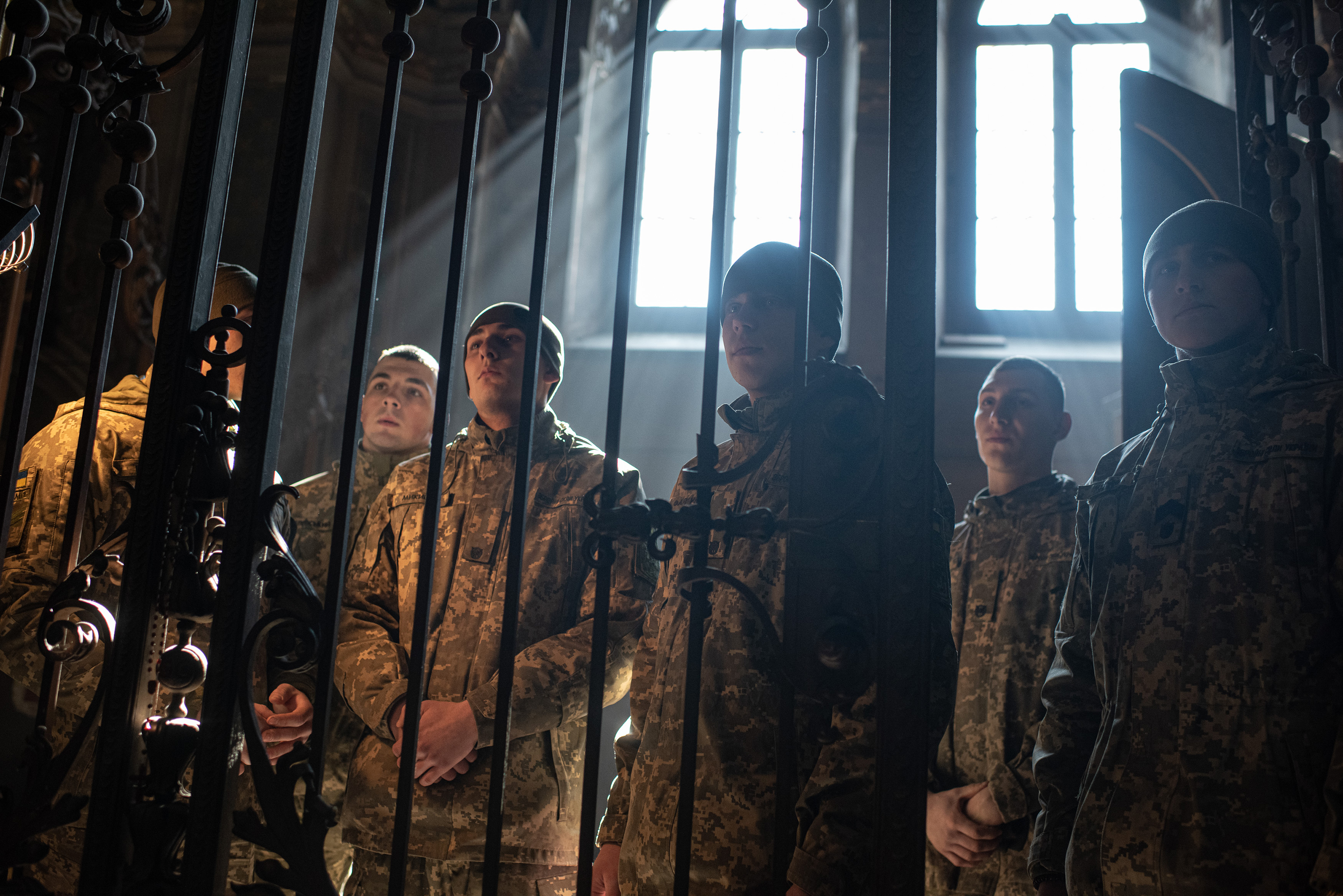 March 15: Ukrainian servicemen sit through a funeral service for Oleh Yaschyshyn, Sergiy Melnyk, Rostyslav Romanchuk and Kyrylo Vyshyvany at a church in Lviv.