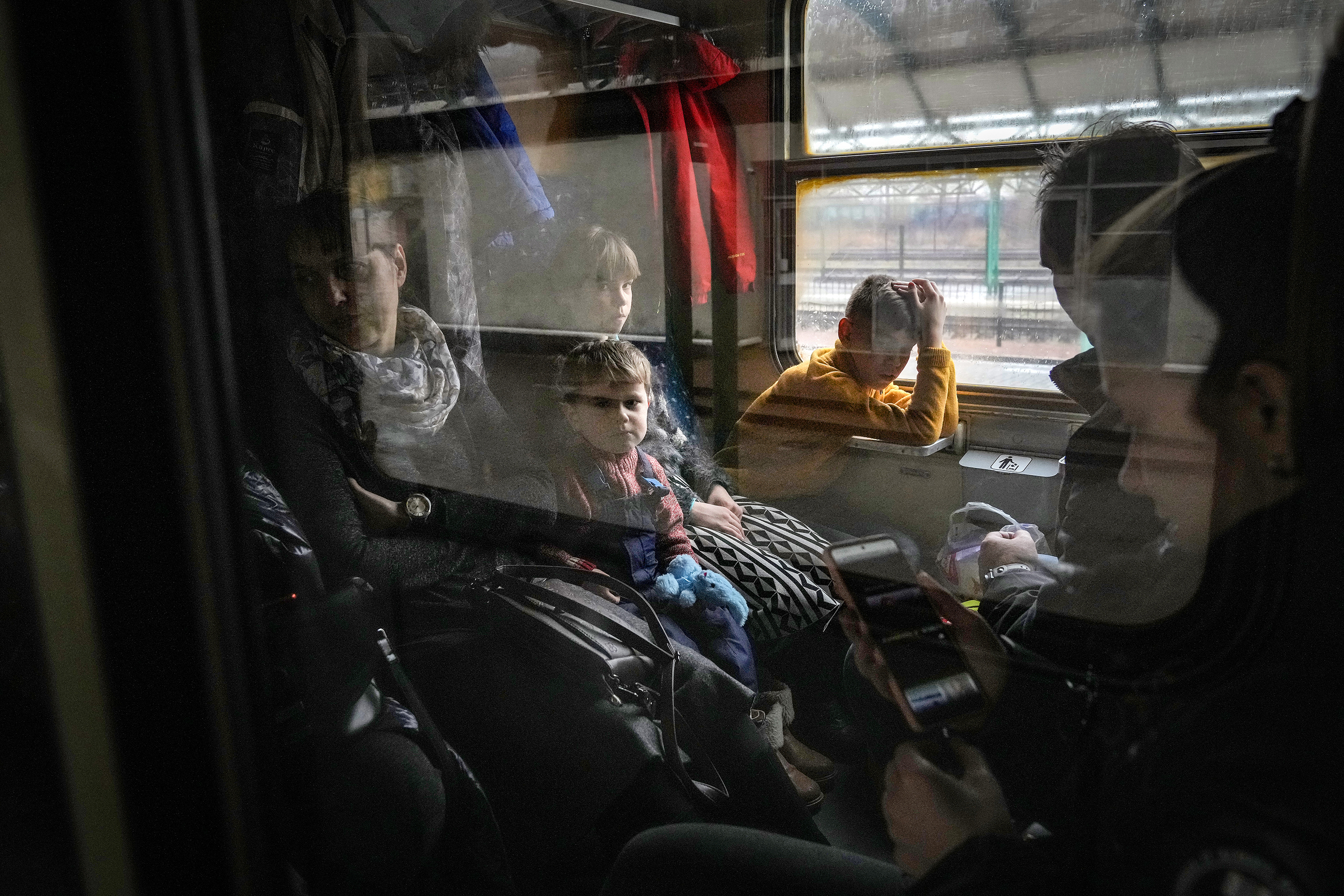 March 16: People fleeing Ukraine travel on a humanitarian train organized by the Slovak Rail Company to bring refugees from Ukraine to Kosice, Slovakia, in Chop, Ukraine. The train departs for Slovakia twice a day, bringing hundreds from Chop, on Ukraine's border with Hungary.