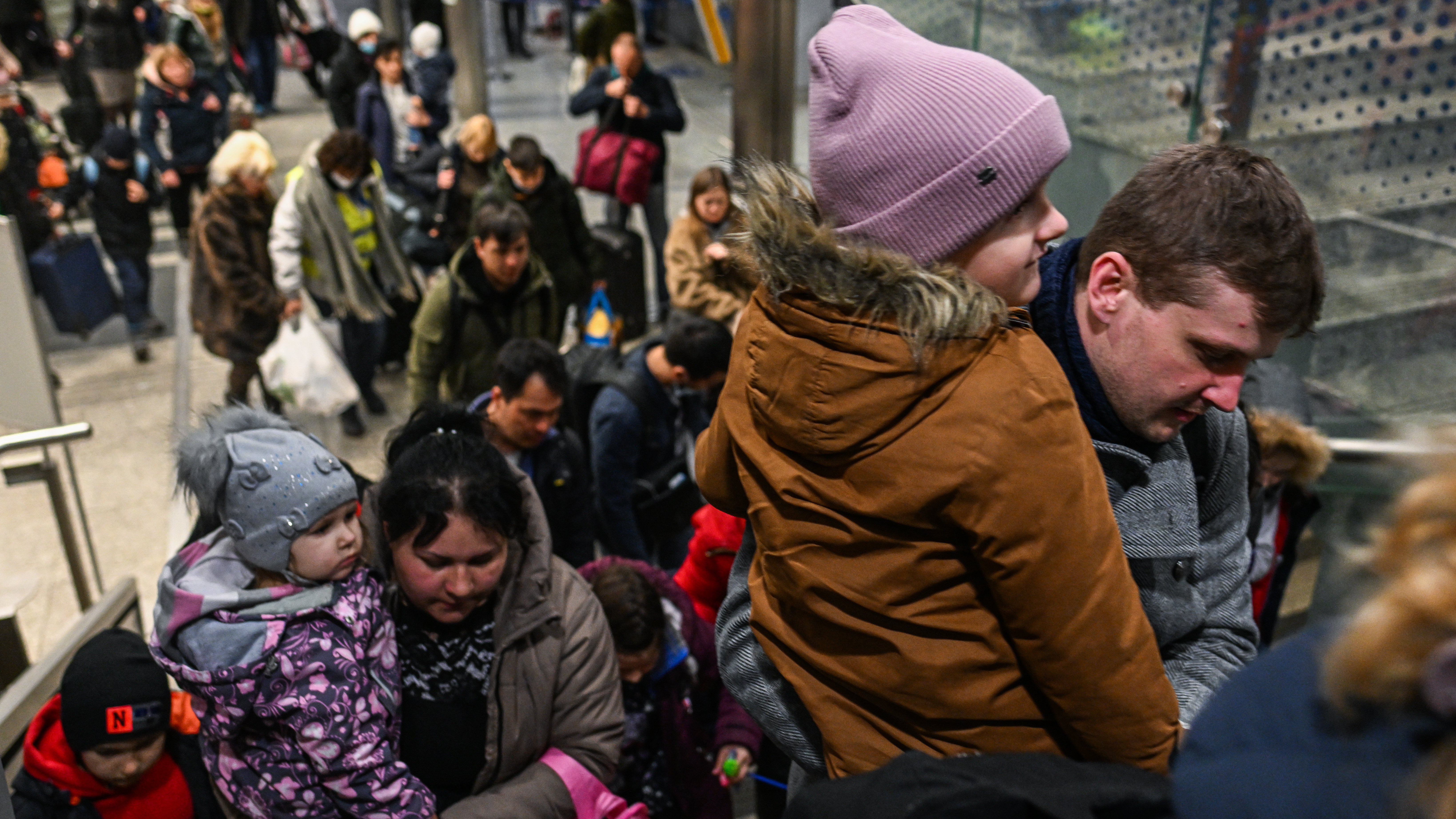 People fleeing the war in Ukraine walk towards a humanitarian train on Friday in Krakow. More than 3.4 million people have left Ukraine since Russia began its invasion almost four weeks ago.