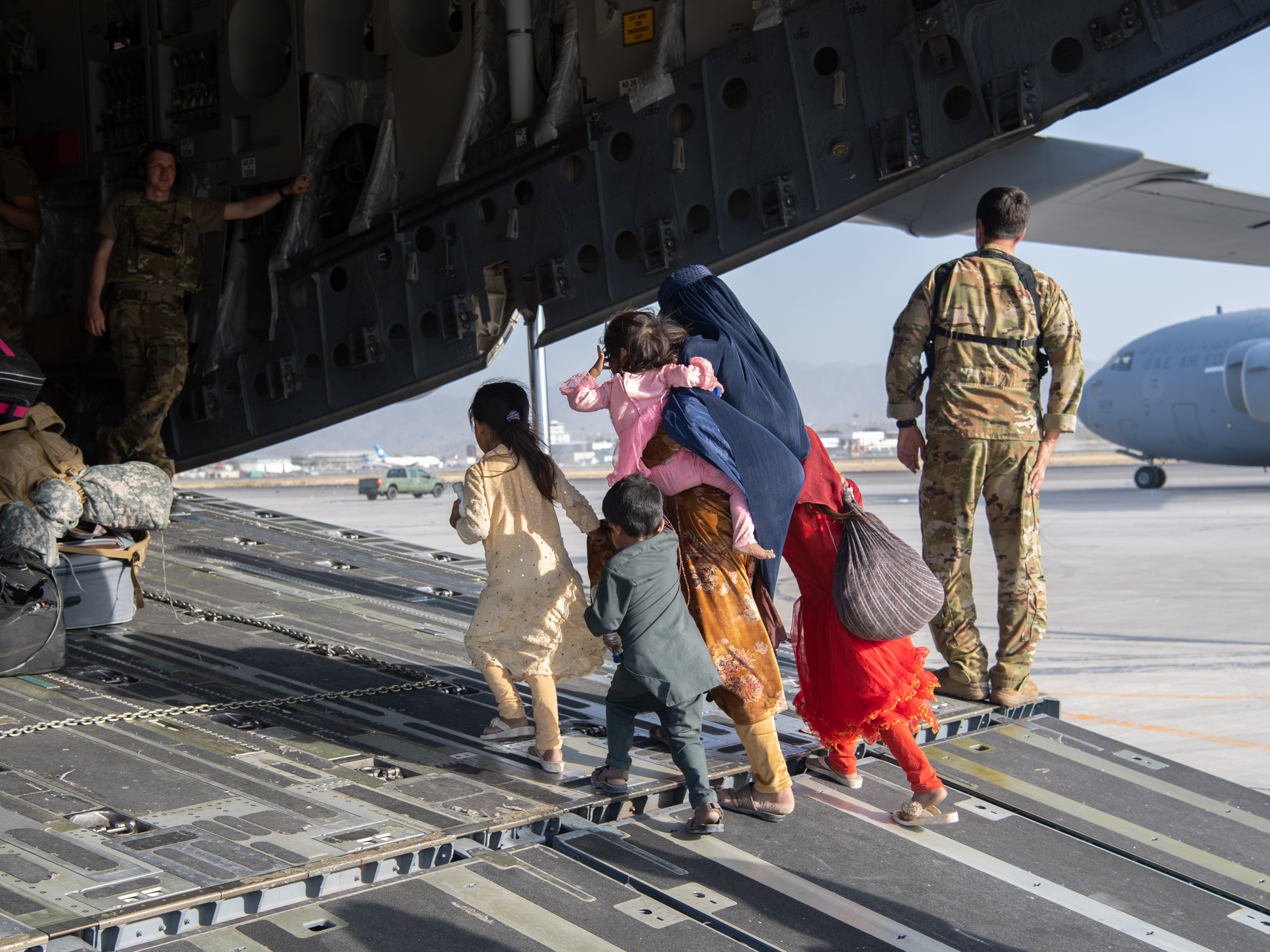 A family enters a U.S. Air Force plane in Kabul, Afghanistan, on Aug. 24, 2021. The evacuation was part of a U.S. effort to relocate Afghans to safety in the wake of the Taliban siege. But many families were separated in the process — and reuniting them has proven to be a challenge. (Master Sgt. Donald R. Allen/U.S. Air Forces Europe-Africa via Getty Images)