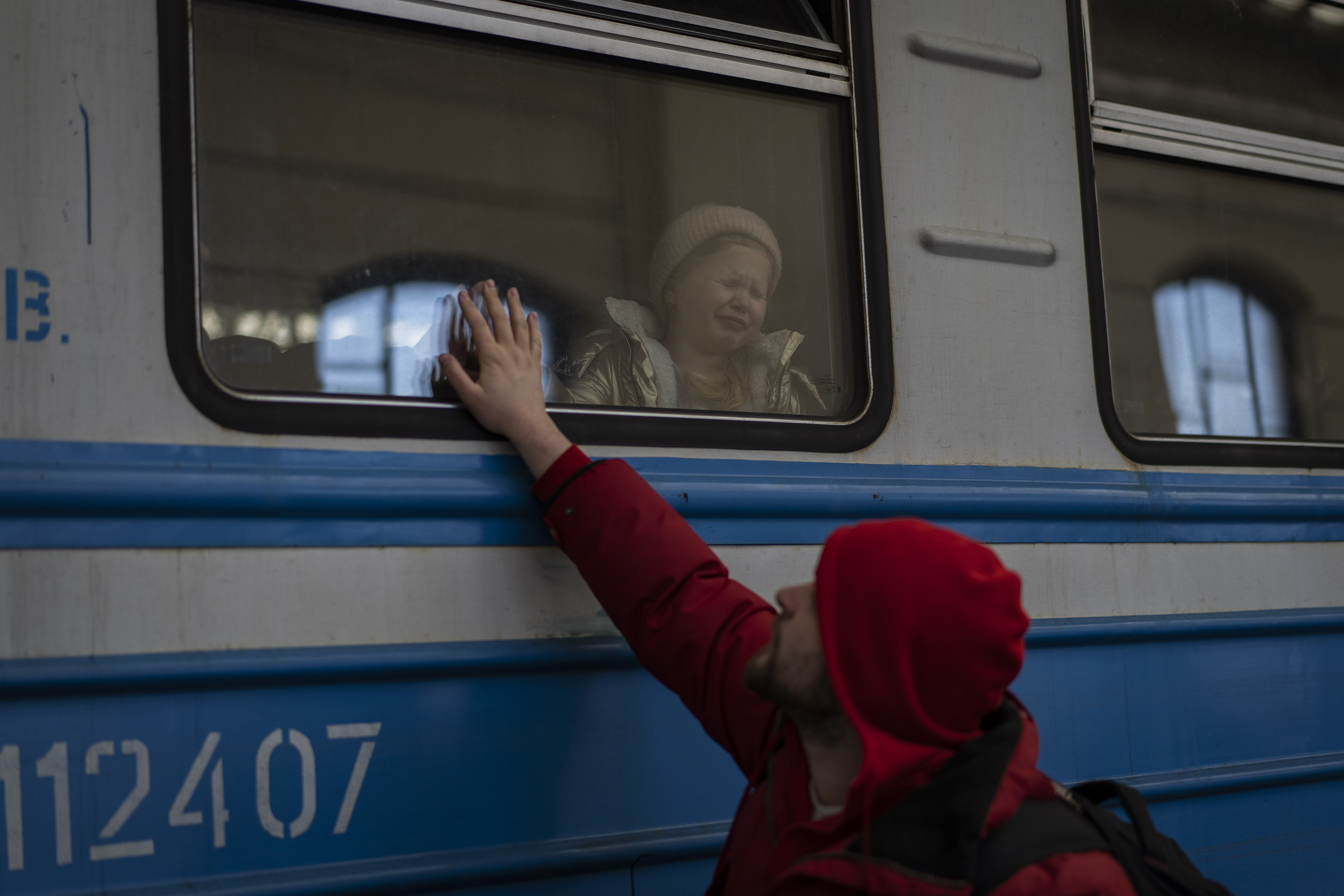 March 22: Displaced Ukrainians on a Poland-bound train bid farewell in Lviv.