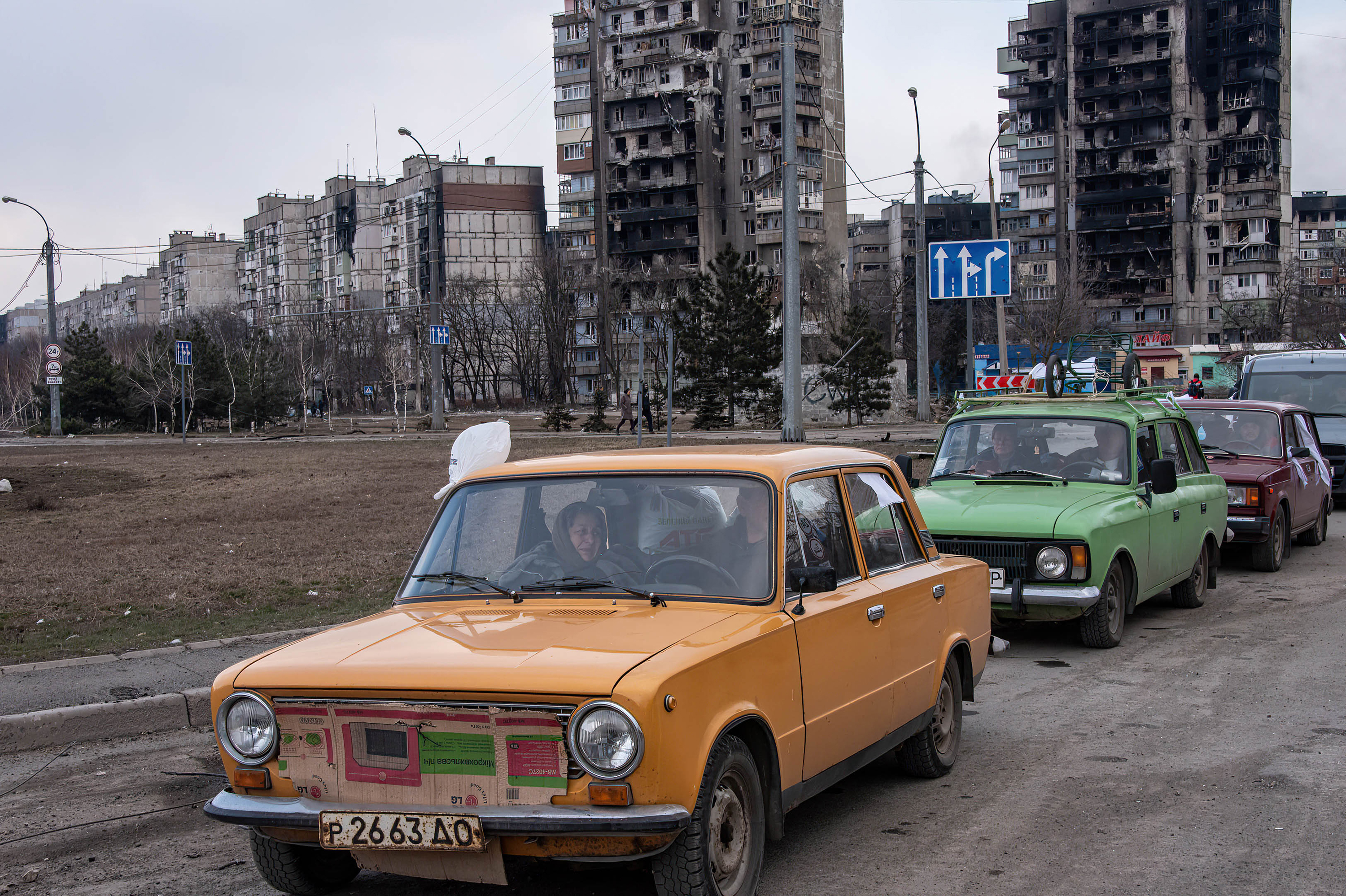 Cars wait in a long line to leave Mariupol, on March 17. The city, on Ukraine's southeastern coast, has been heavily damaged by Russian bombardment. (SOPA Images/LightRocket/Getty Images)